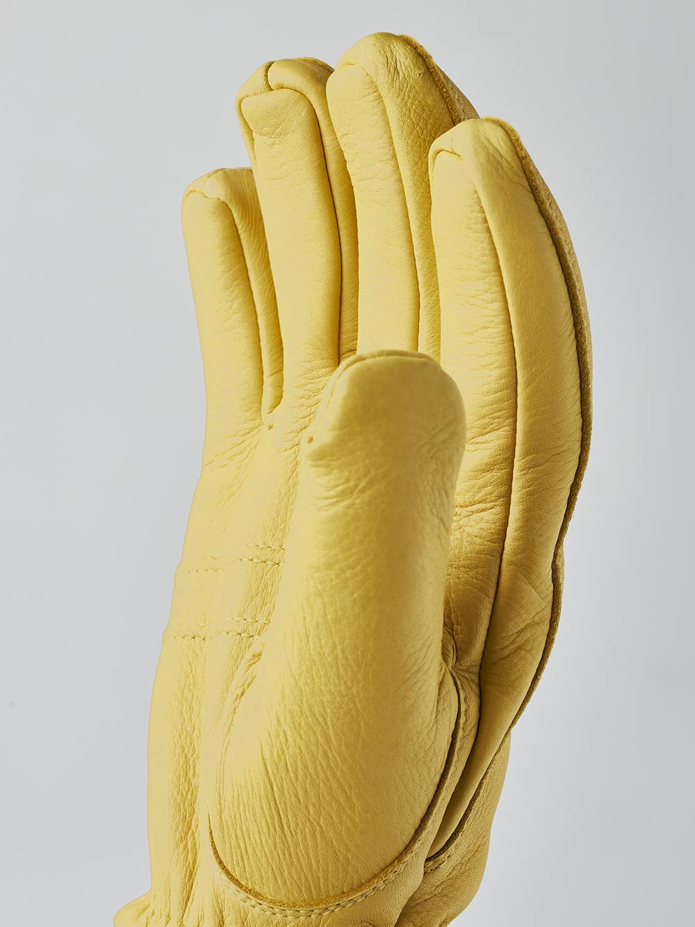 Yellow machine-sewn deerskin glove with knitted cuff
 (7 of 8)
