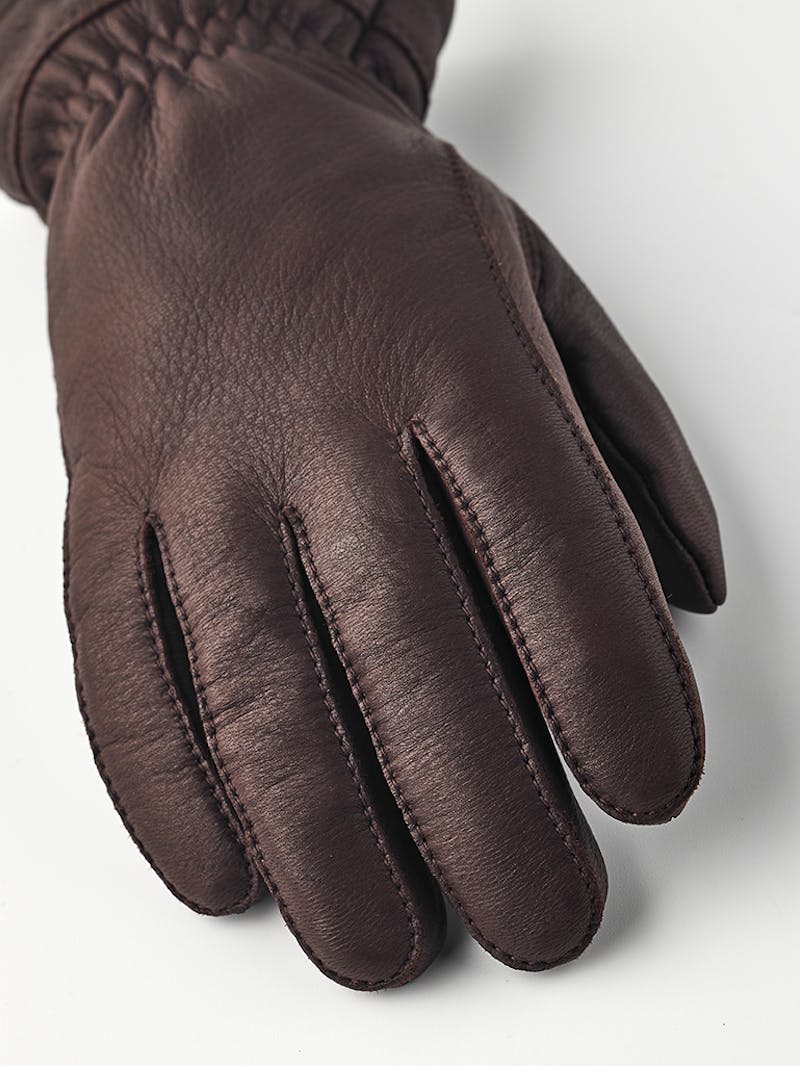 Brown machine-sewn deerskin glove with white trim
 (2 of 4)