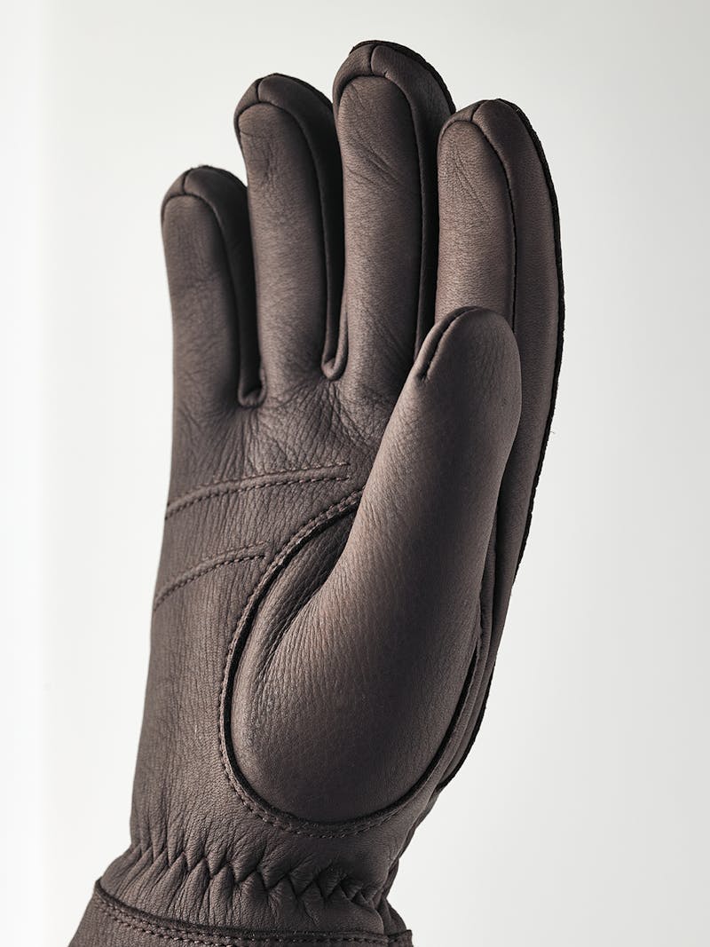Dark brown machine-sewn deerskin glove with white trim
 (4 of 4)