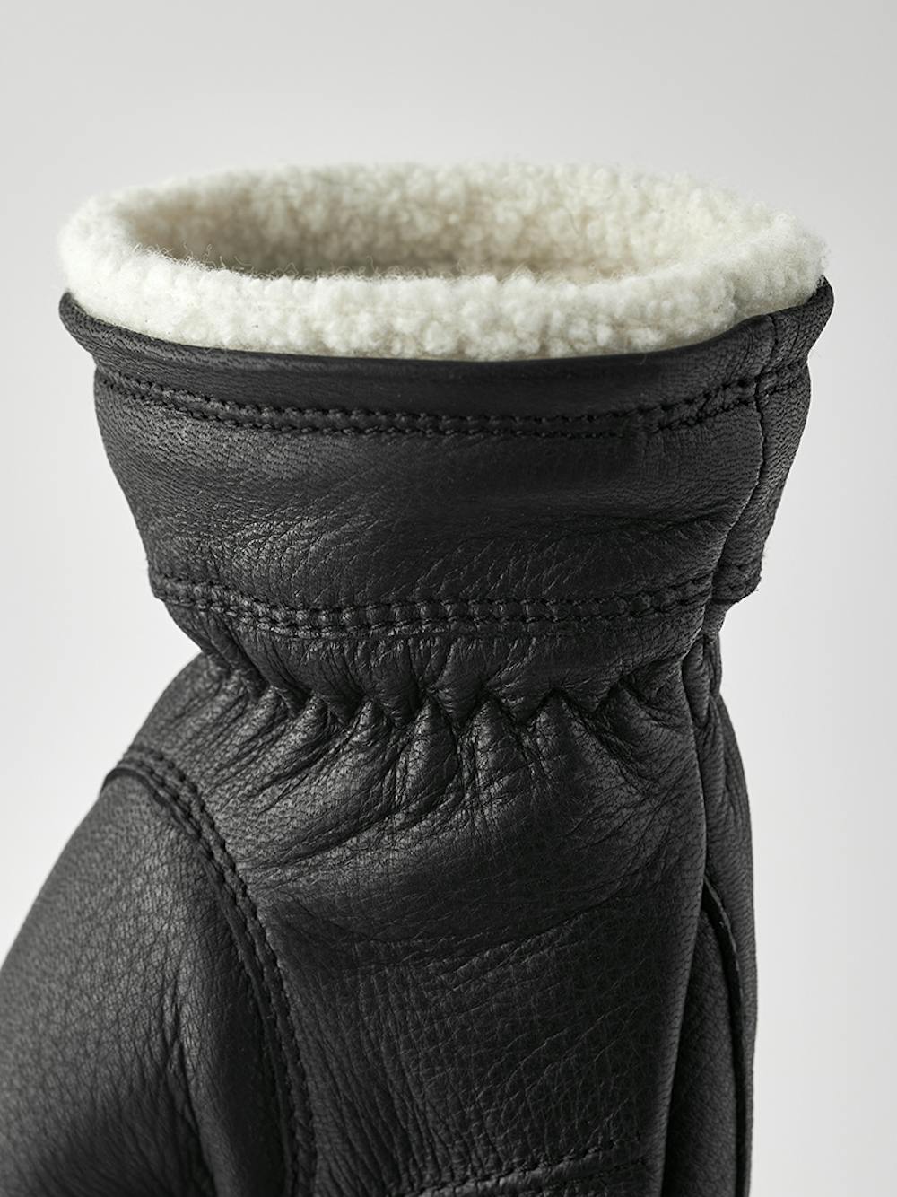 Black machine-sewn deerskin glove with white trim
 (3 of 4)