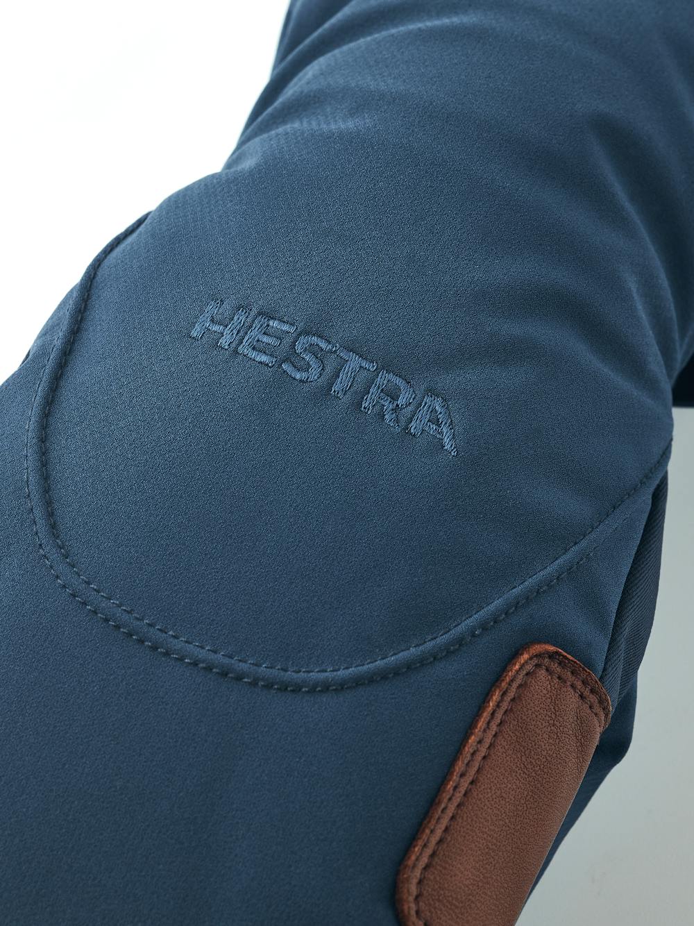 Mörkblå tumhandske i tyg med mörkbrun lammnappa i innerhanden
 (4 av 5)