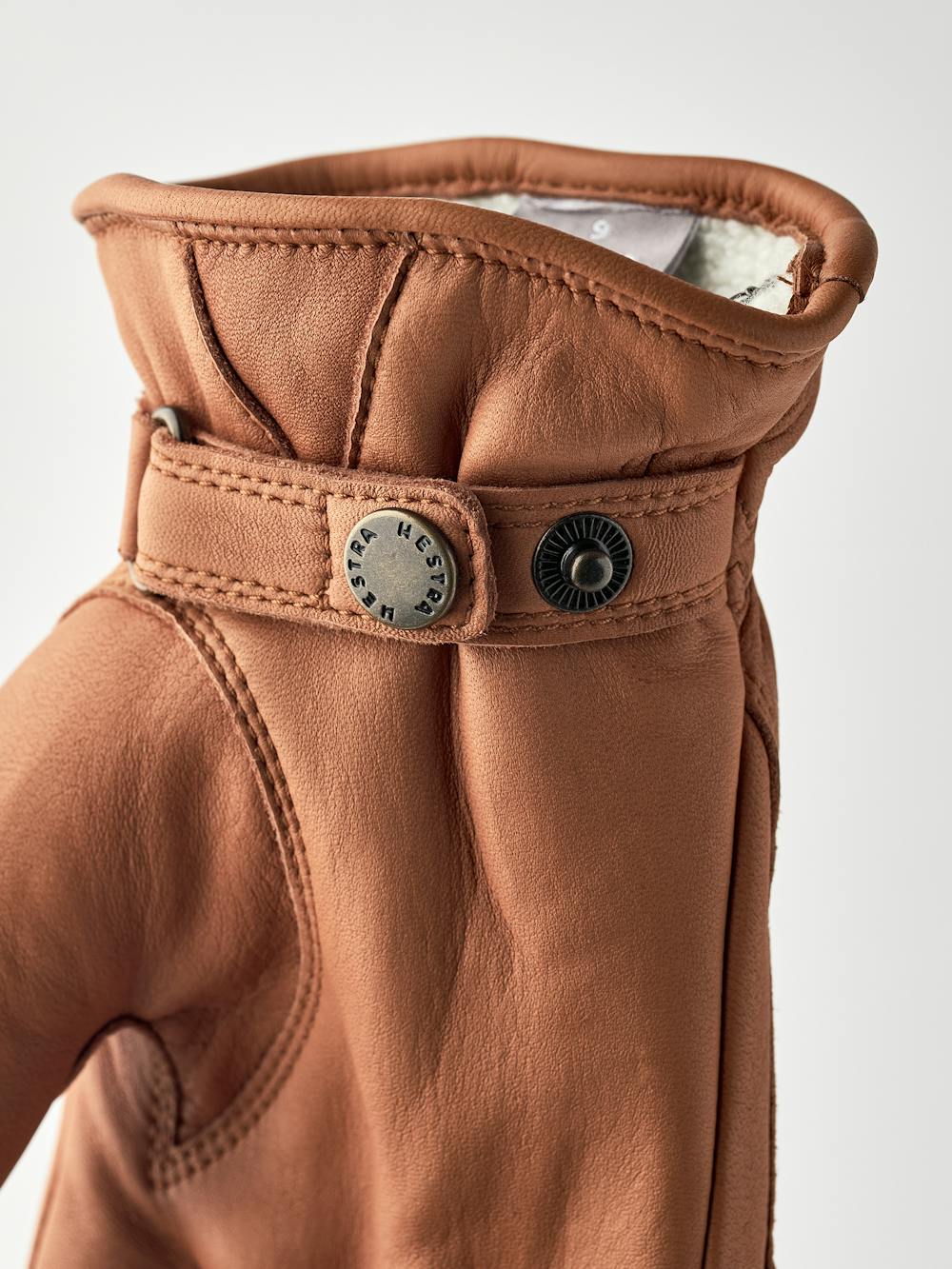 Light brown machine-sewn hairsheep leather glove with leather strap and button
 (5 of 5)