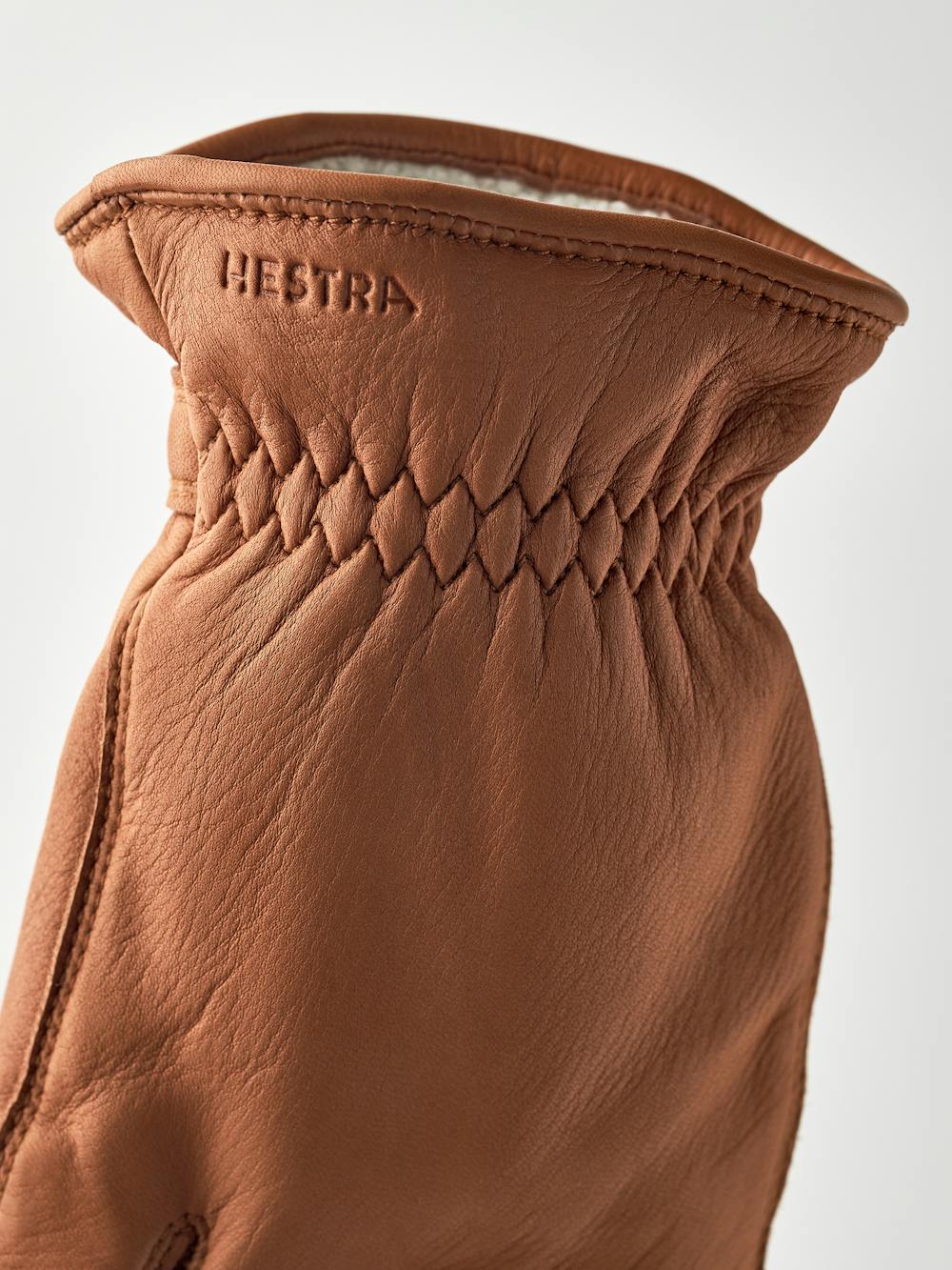 Light brown machine-sewn hairsheep leather glove with leather strap and button
 (4 of 5)
