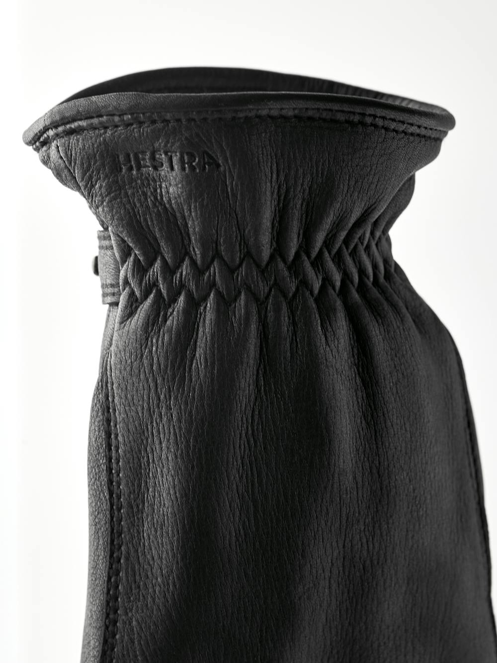 Black machine-sewn hairsheep leather glove with leather strap and button
 (4 of 5)