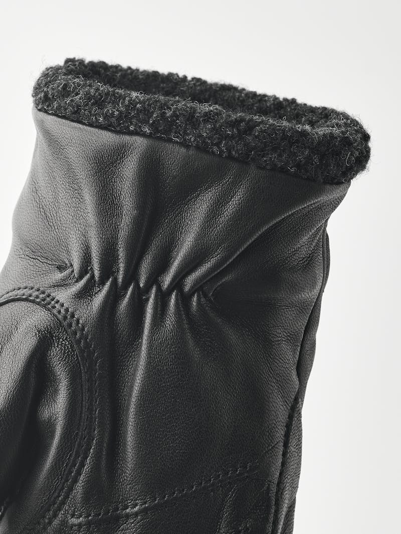 Black machine-sewn hairsheep leather mitten with visible wool fleece trim
 (4 of 5)