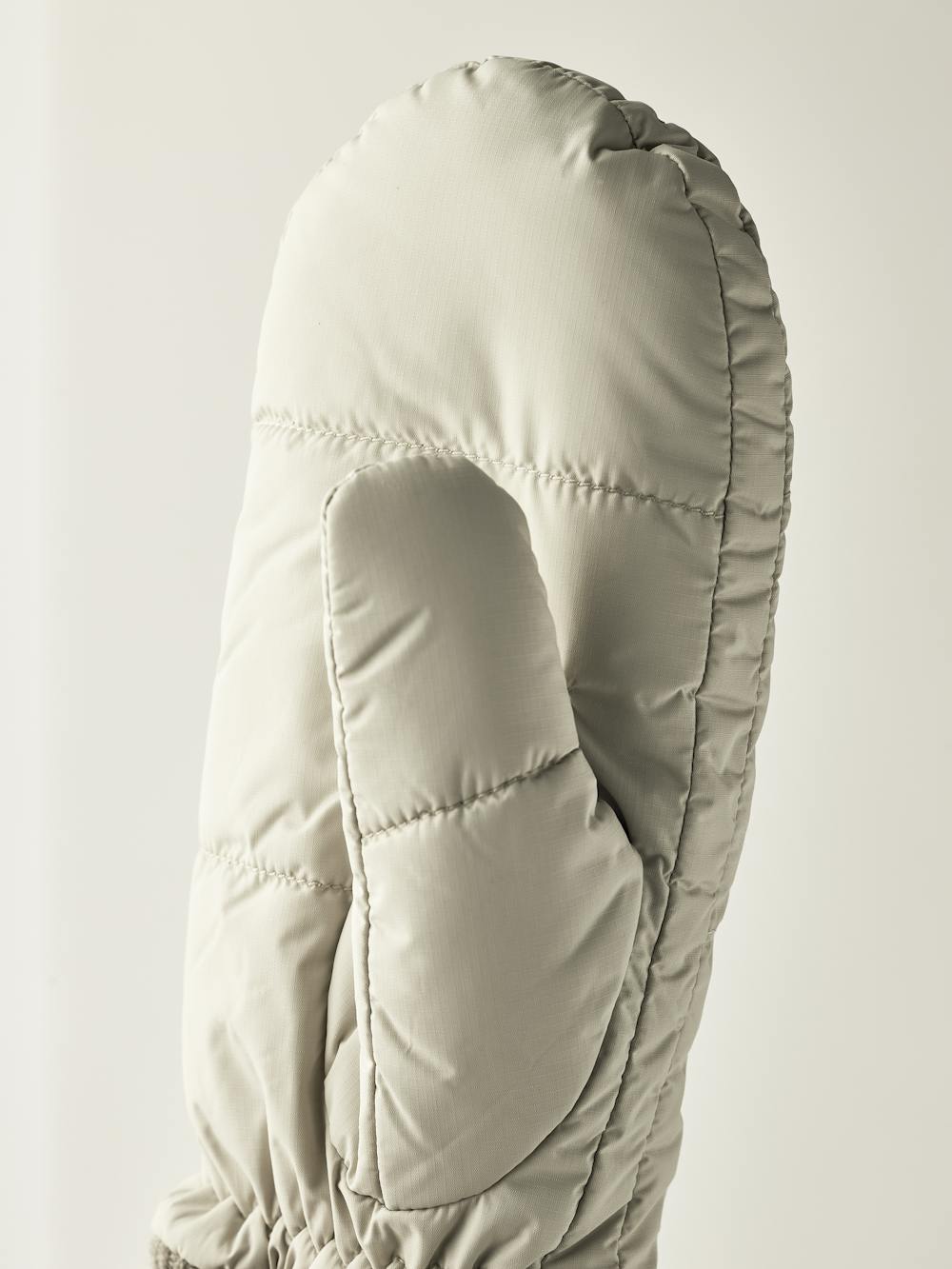 Light beige fabric mitten with light gray knitted cuff
(2 of 3)