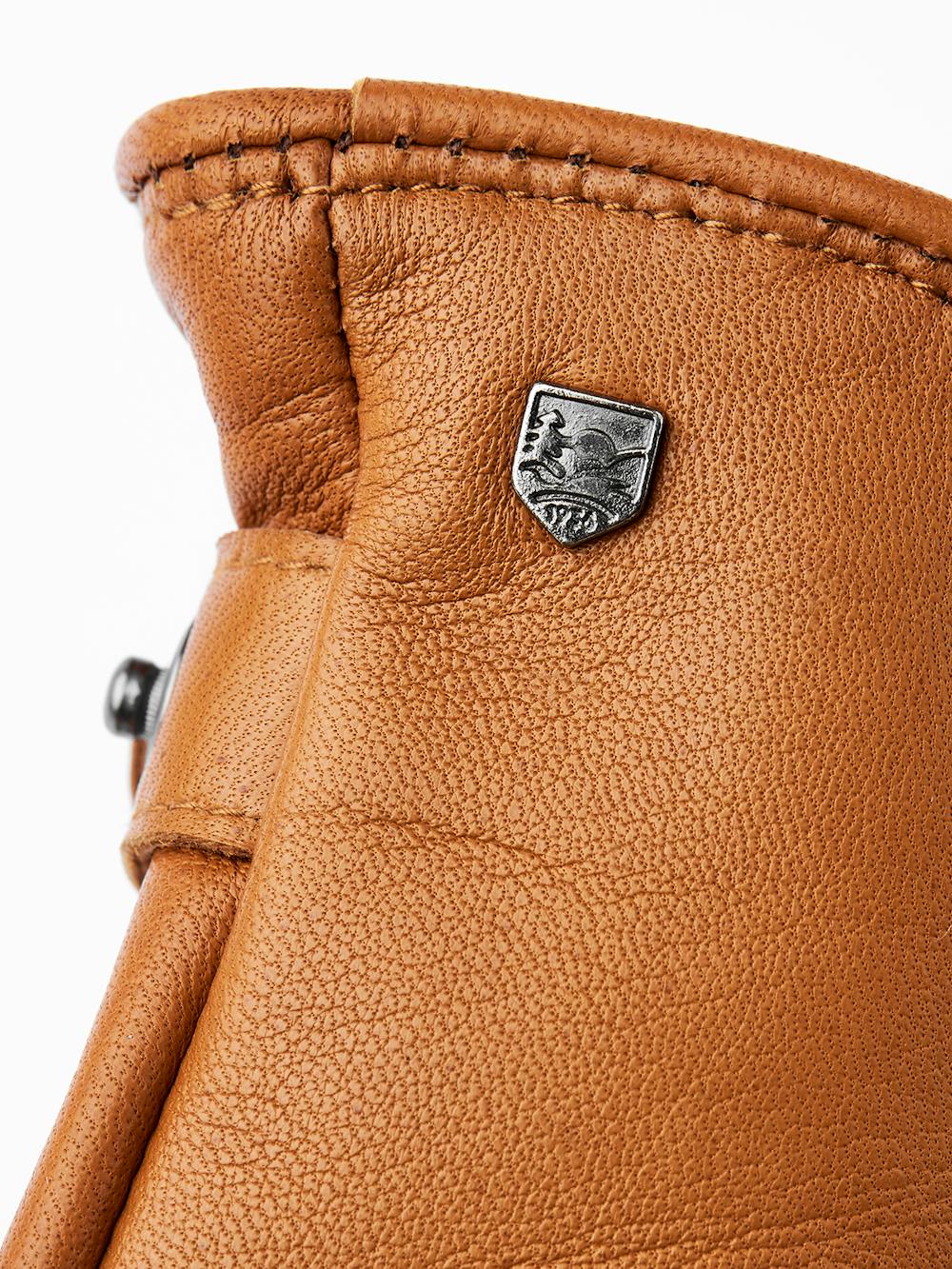 Light brownish-yellow machine-sewn hairsheep leather glove with leather strap
(3 of 3)