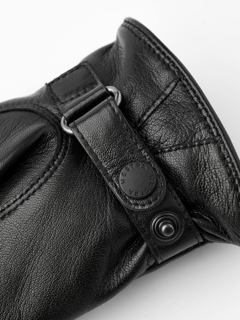 Black machine-sewn hairsheep leather glove with leather strap
(2 of 3)