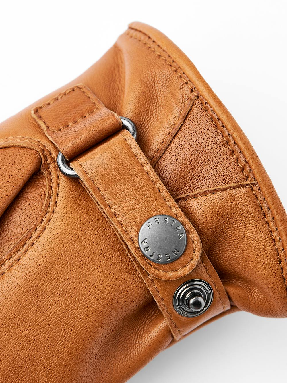 Light brownish-yellow machine-sewn hairsheep leather glove with leather strap
(2 of 3)
