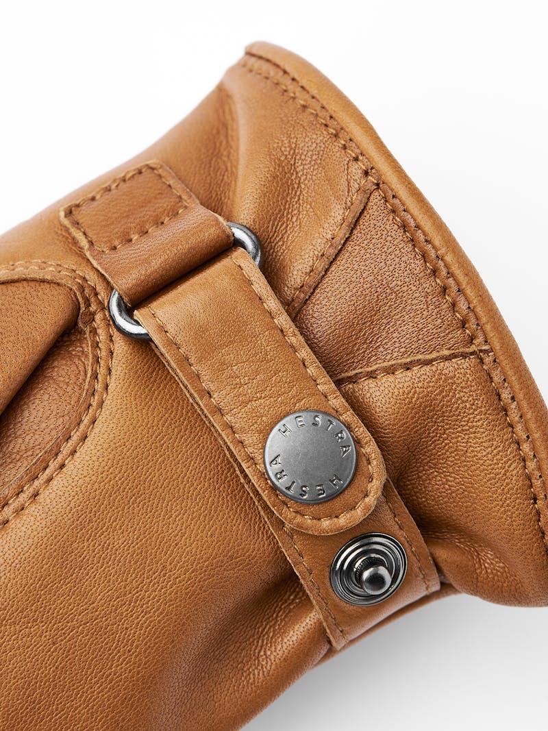 Light brownish-yellow machine-sewn hairsheep leather glove with leather strap
 (2 of 3)