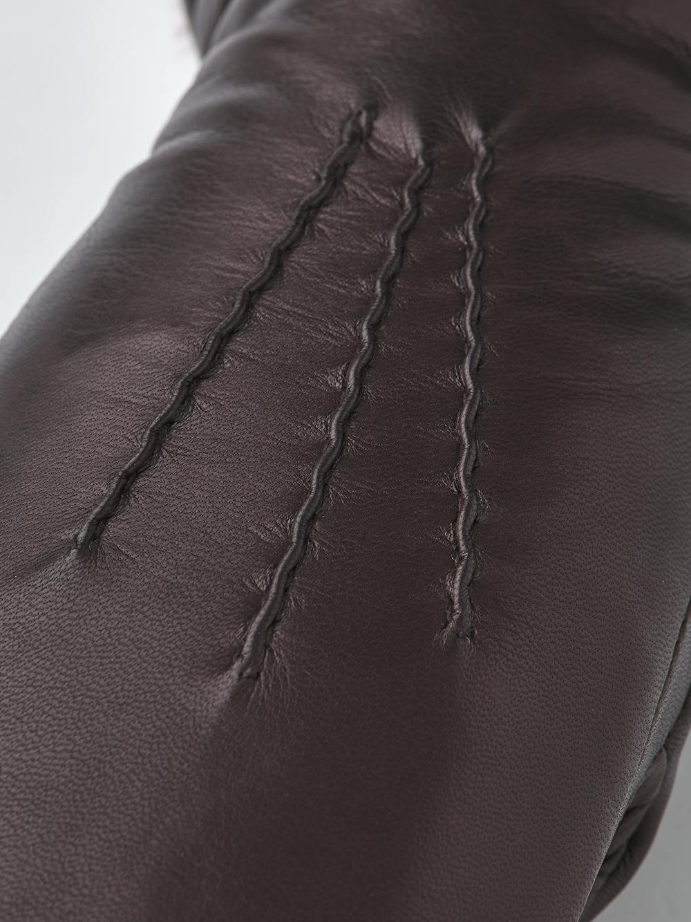 Dark brown machine-sewn hairsheep leather mitten with white fur trim
 (3 of 5)