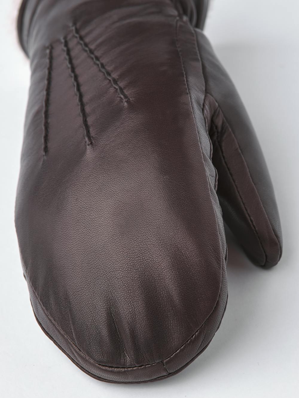 Dark brown machine-sewn hairsheep leather mitten with white fur trim
(4 of 5)
