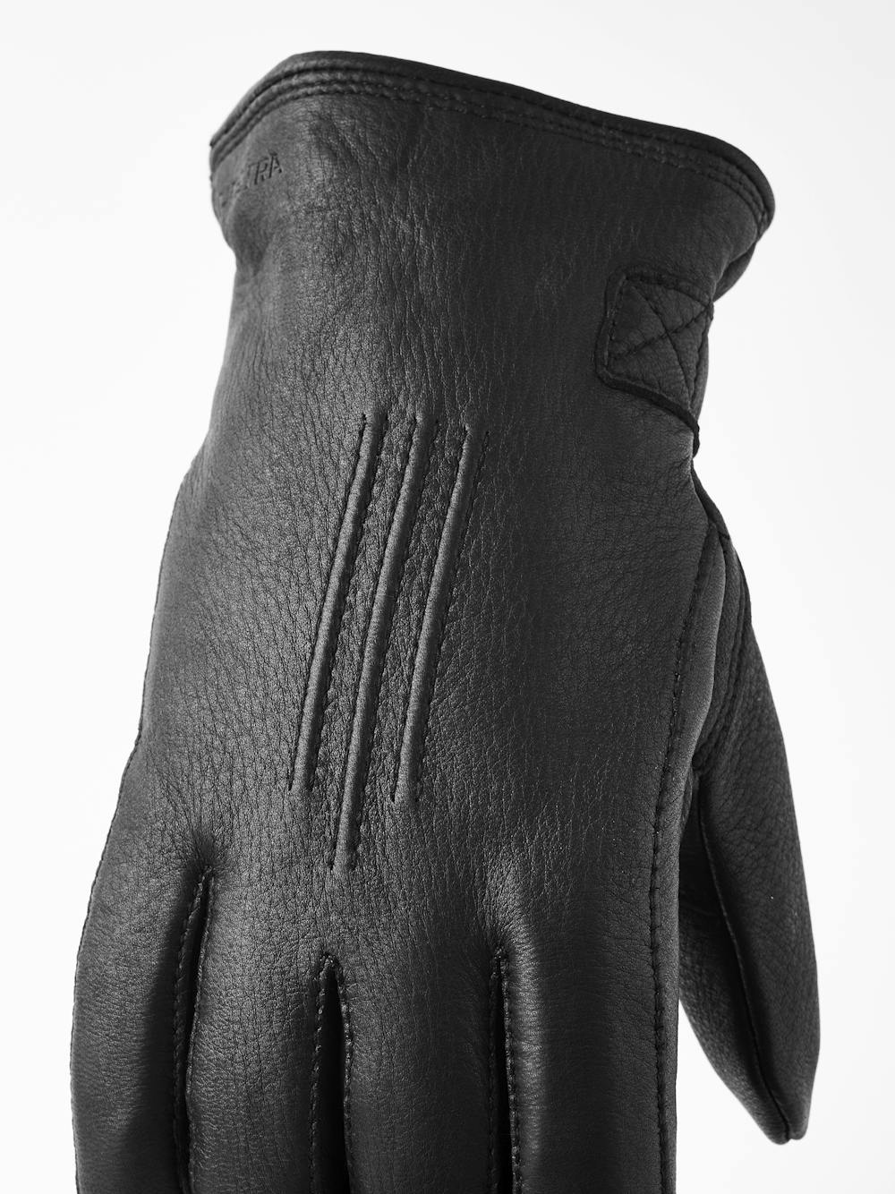 Black machine-sewn deerskin glove with leather strap and button
 (3 of 5)