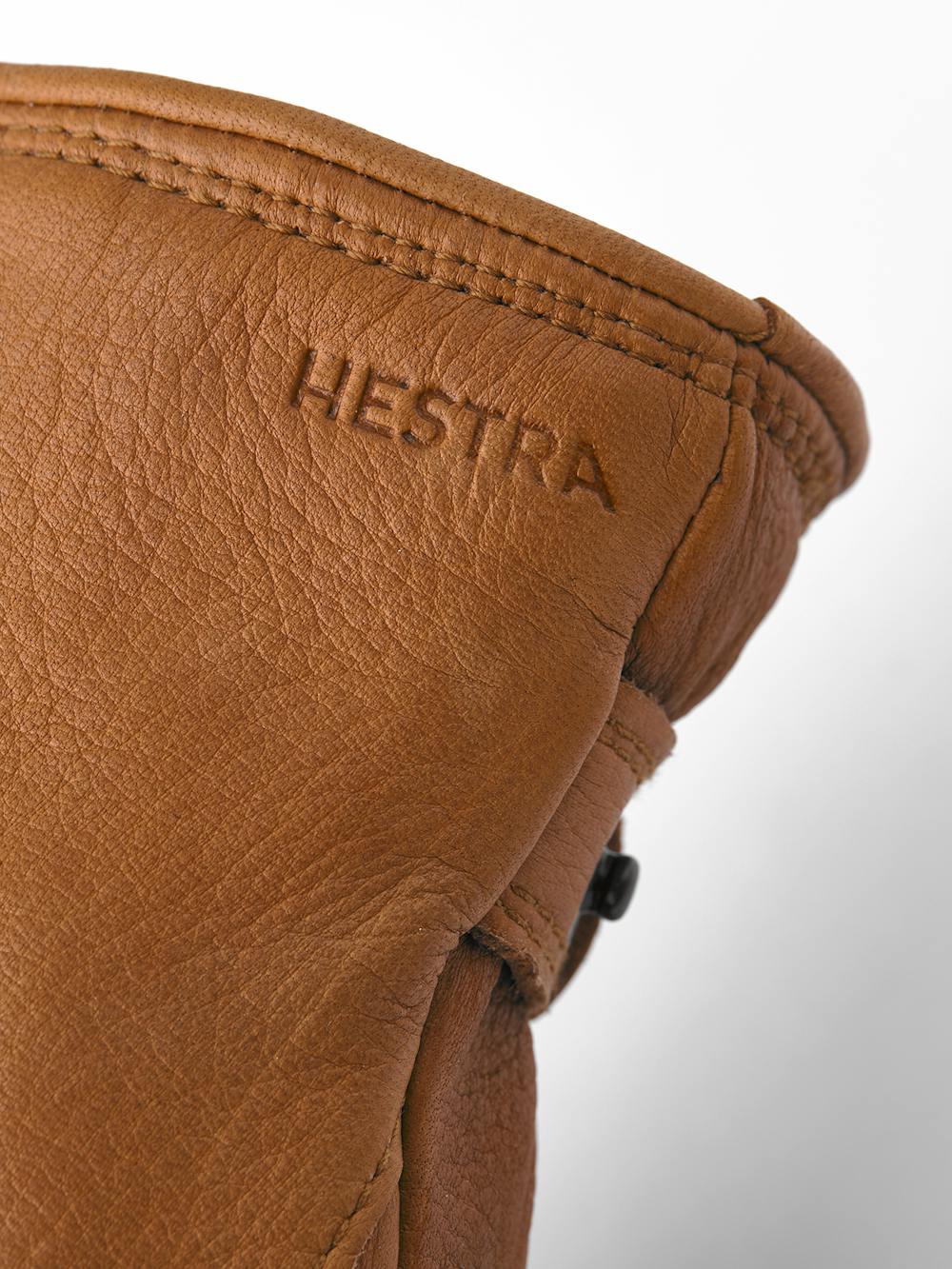 Light brown machine-sewn deerskin glove with leather strap and button
 (2 of 5)