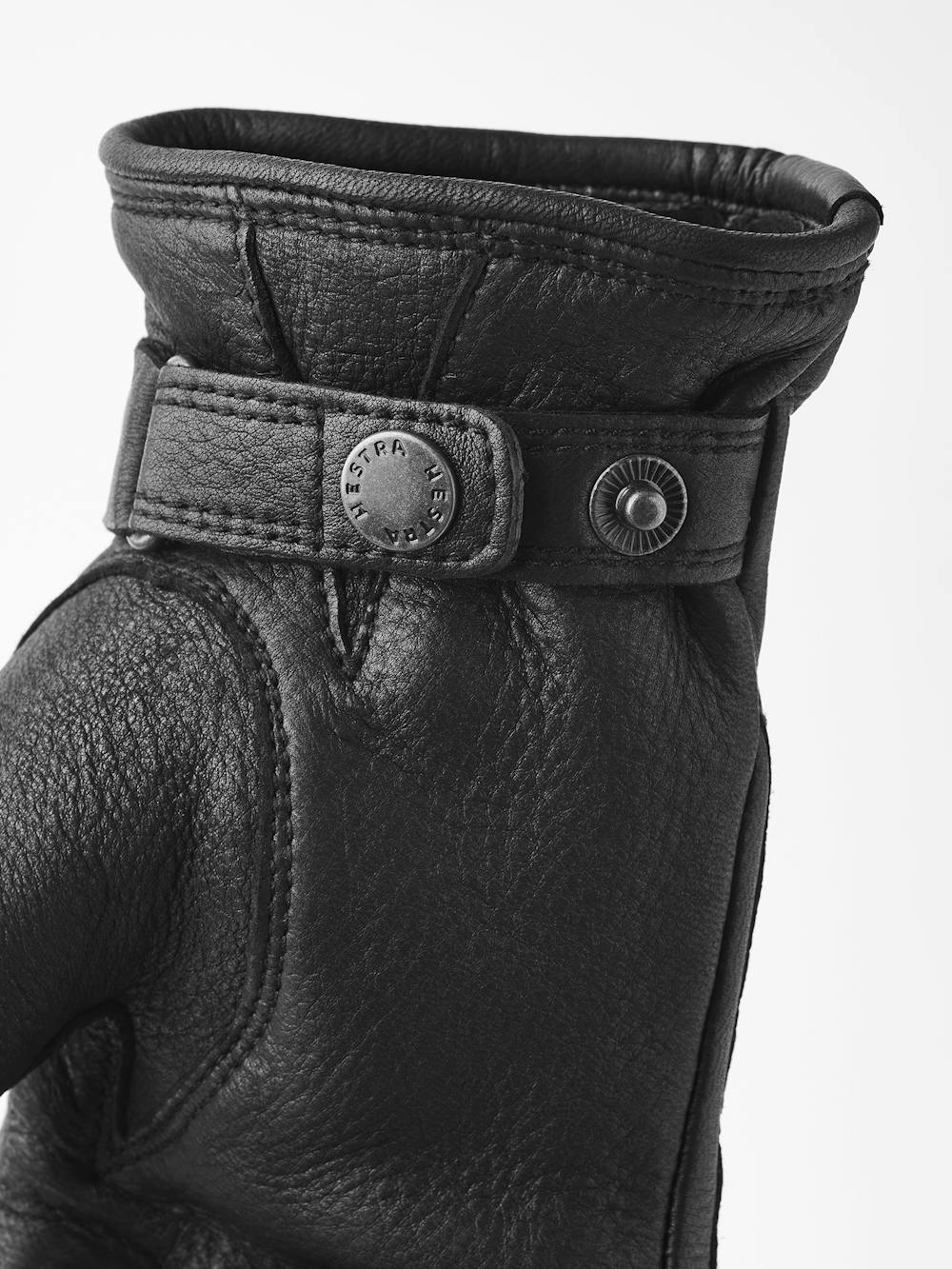 Black machine-sewn deerskin glove with leather strap and button
(4 of 5)