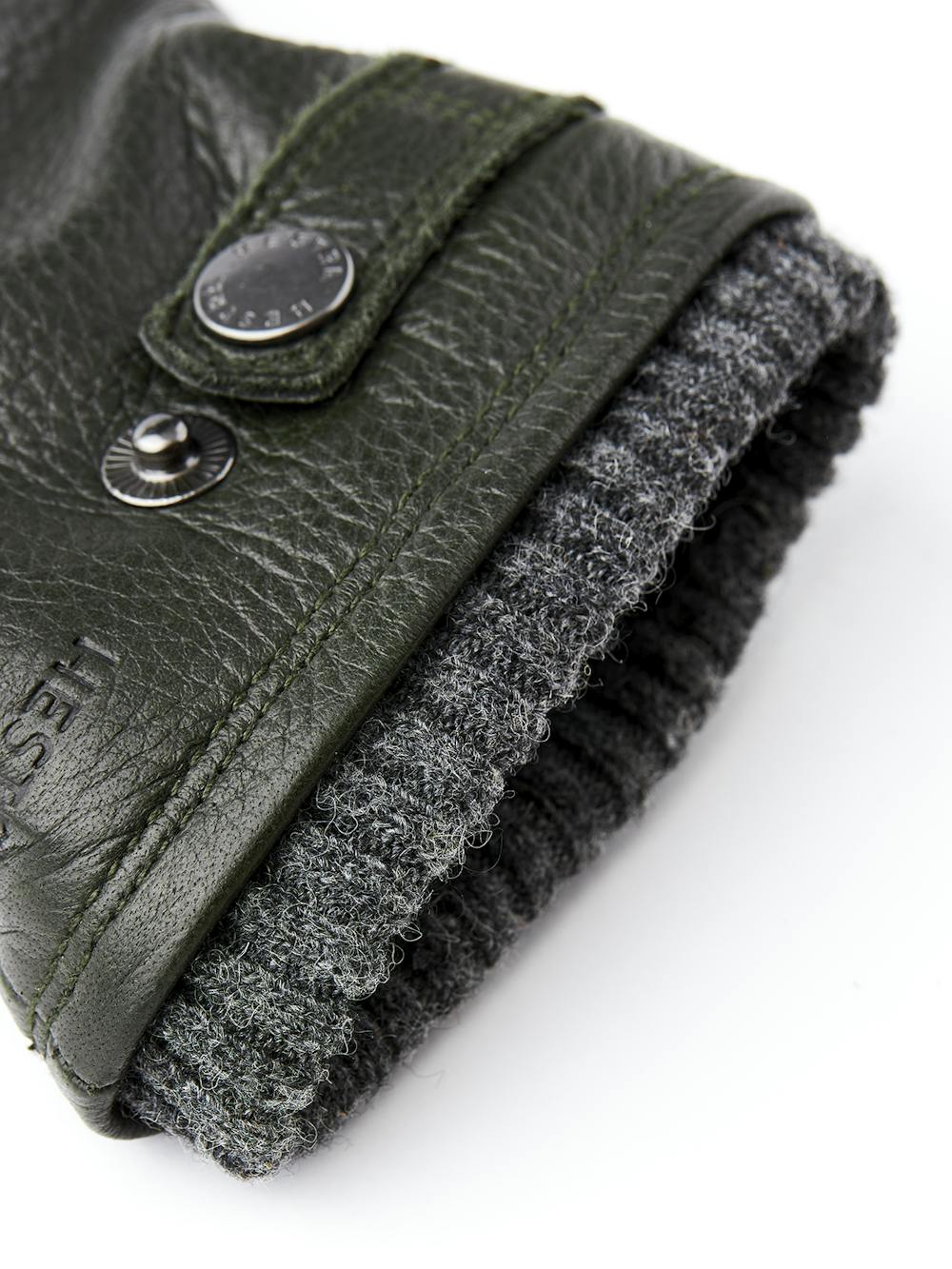 Dark green machine-sewn elk leather glove with leather strap and button
(3 of 3)