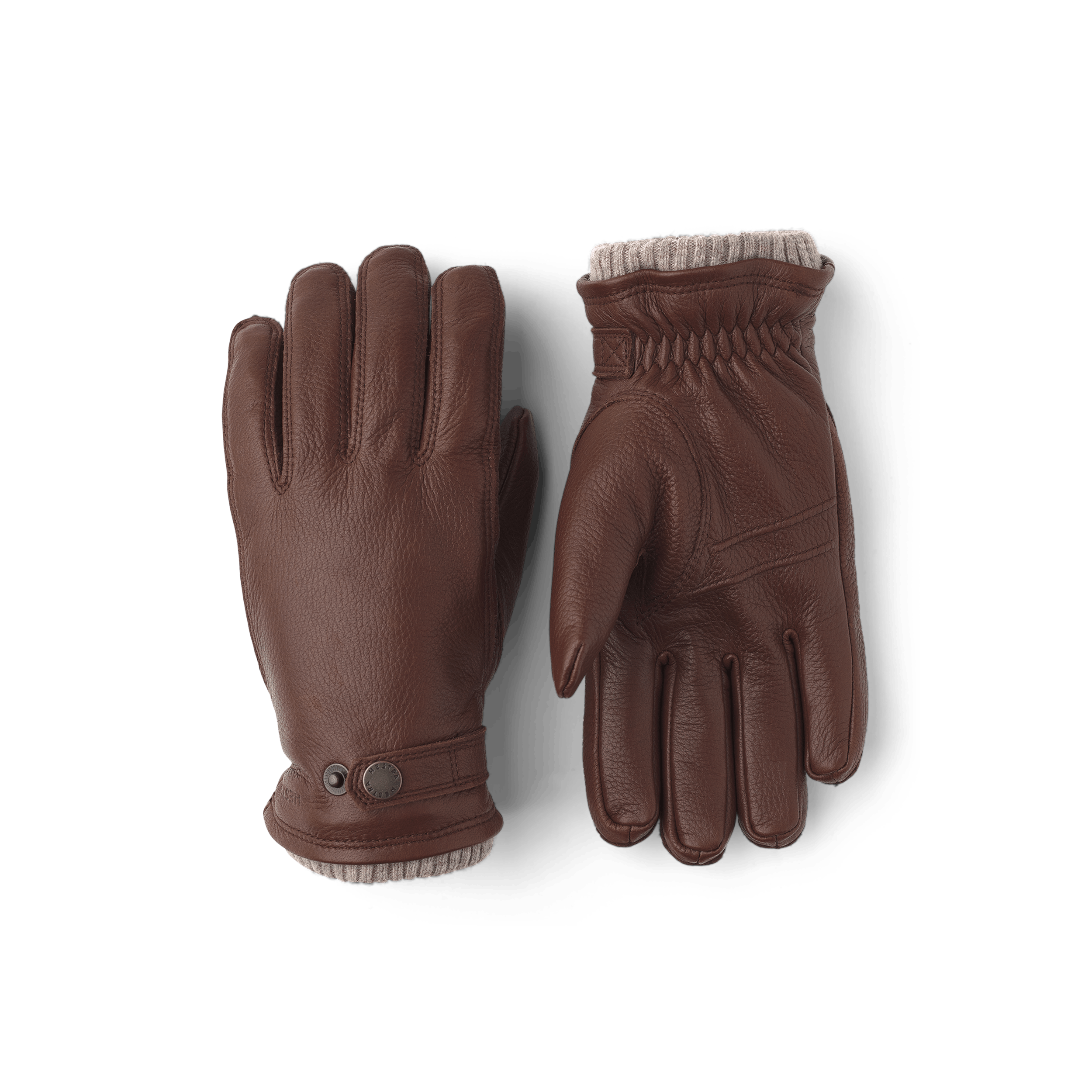 Brun maskinsydd handske i älgskinn med läderrem och knapp
(1 av 3)