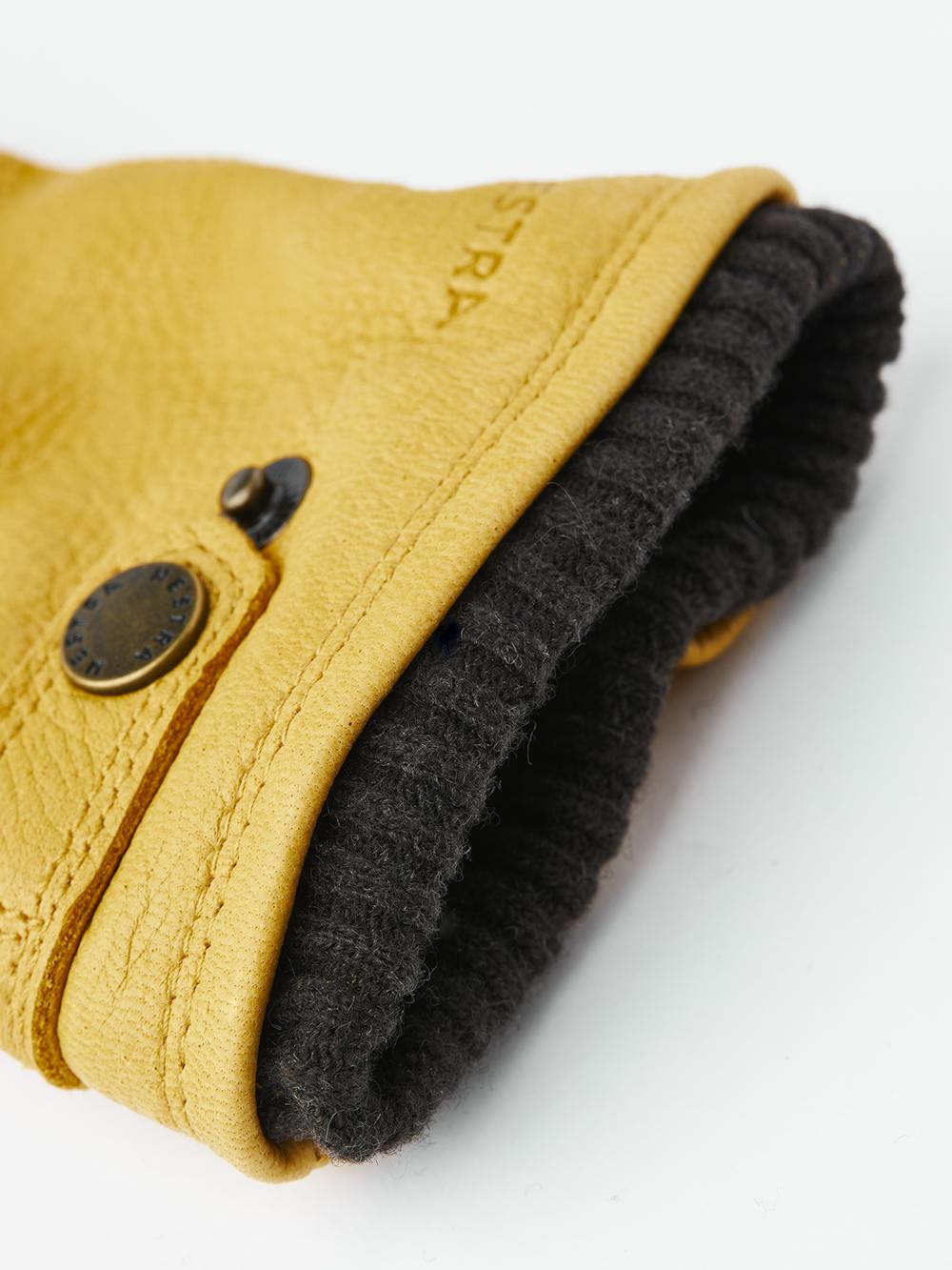 Yellow machine-sewn elk leather glove with leather strap and button
(3 of 3)