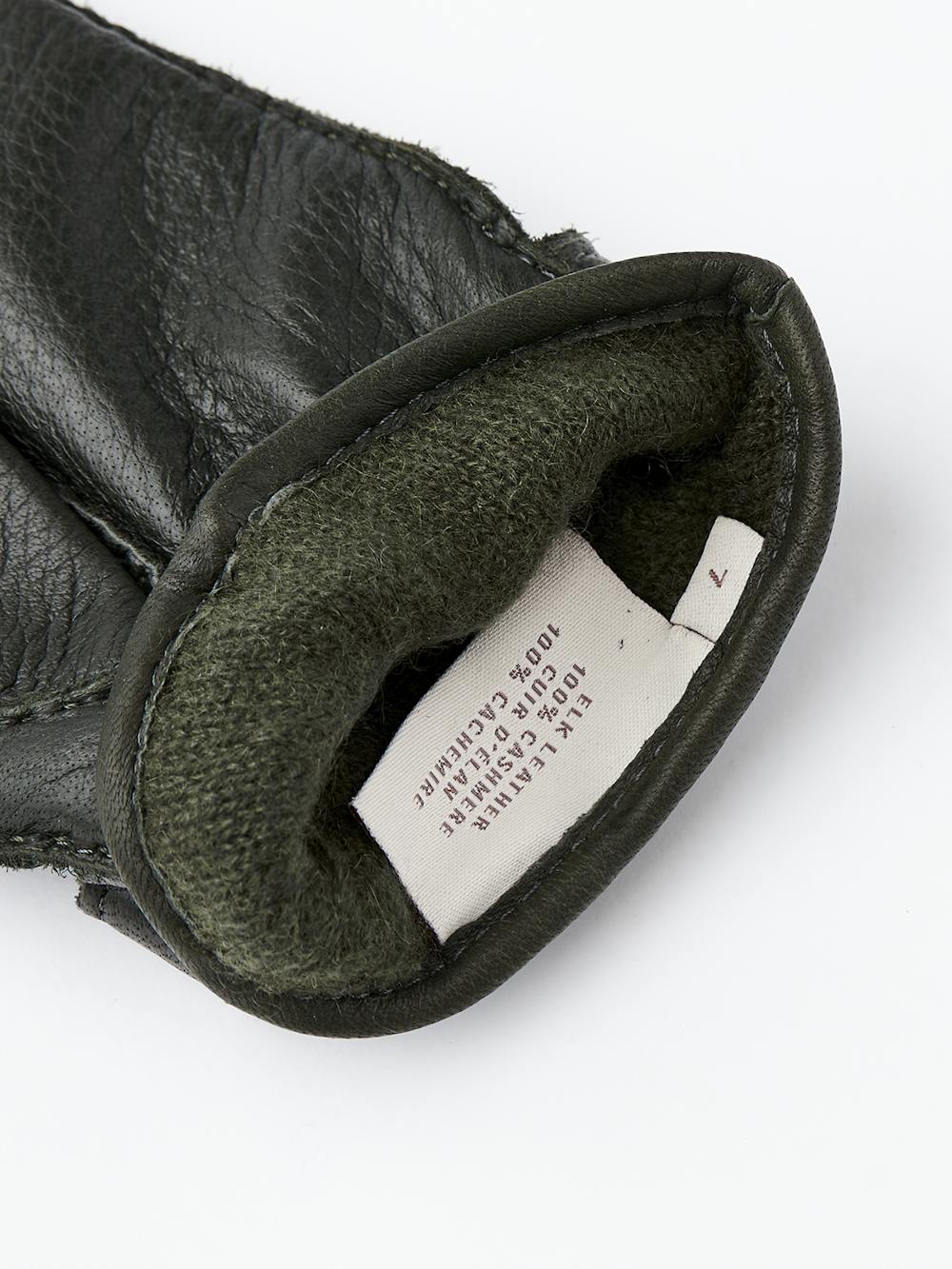 Dark green hand-sewn elk leather glove with leather strap and button
(5 of 5)