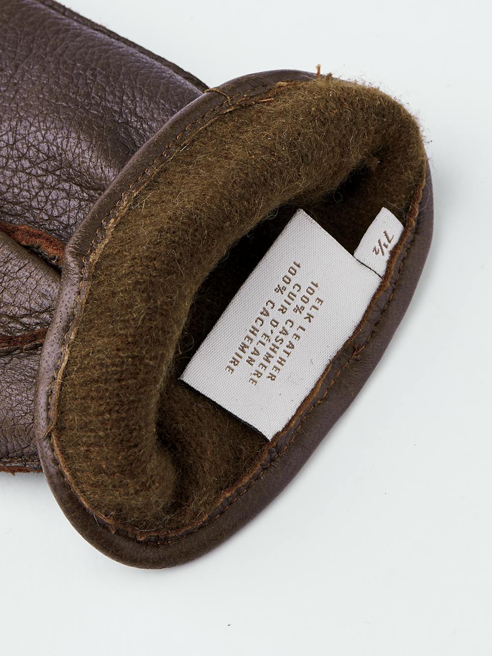 Brown hand-sewn elk leather glove with leather strap and button
(5 of 5)