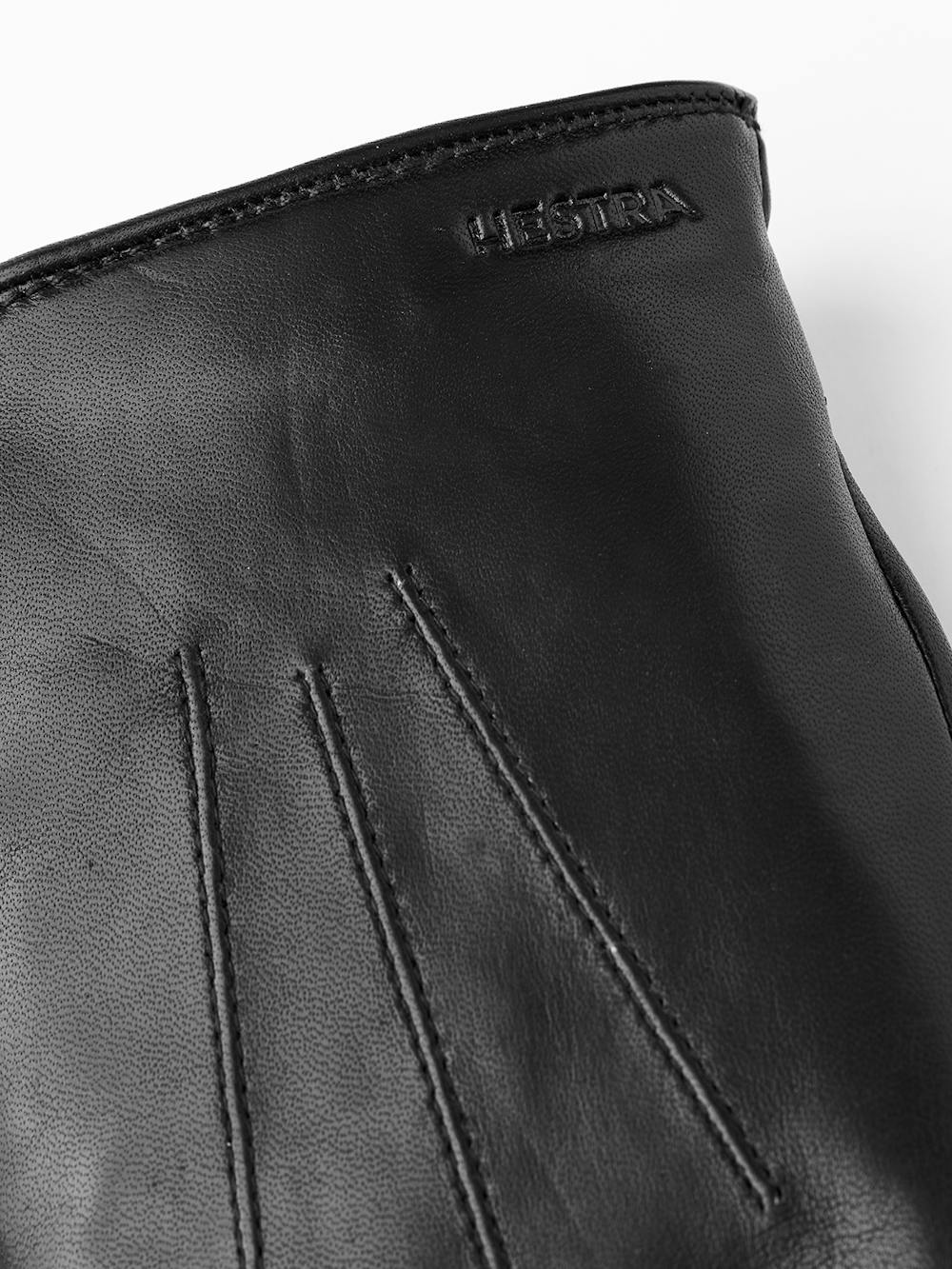 Black machine-sewn hairsheep leather glove with leather strap and button
 (2 of 4)