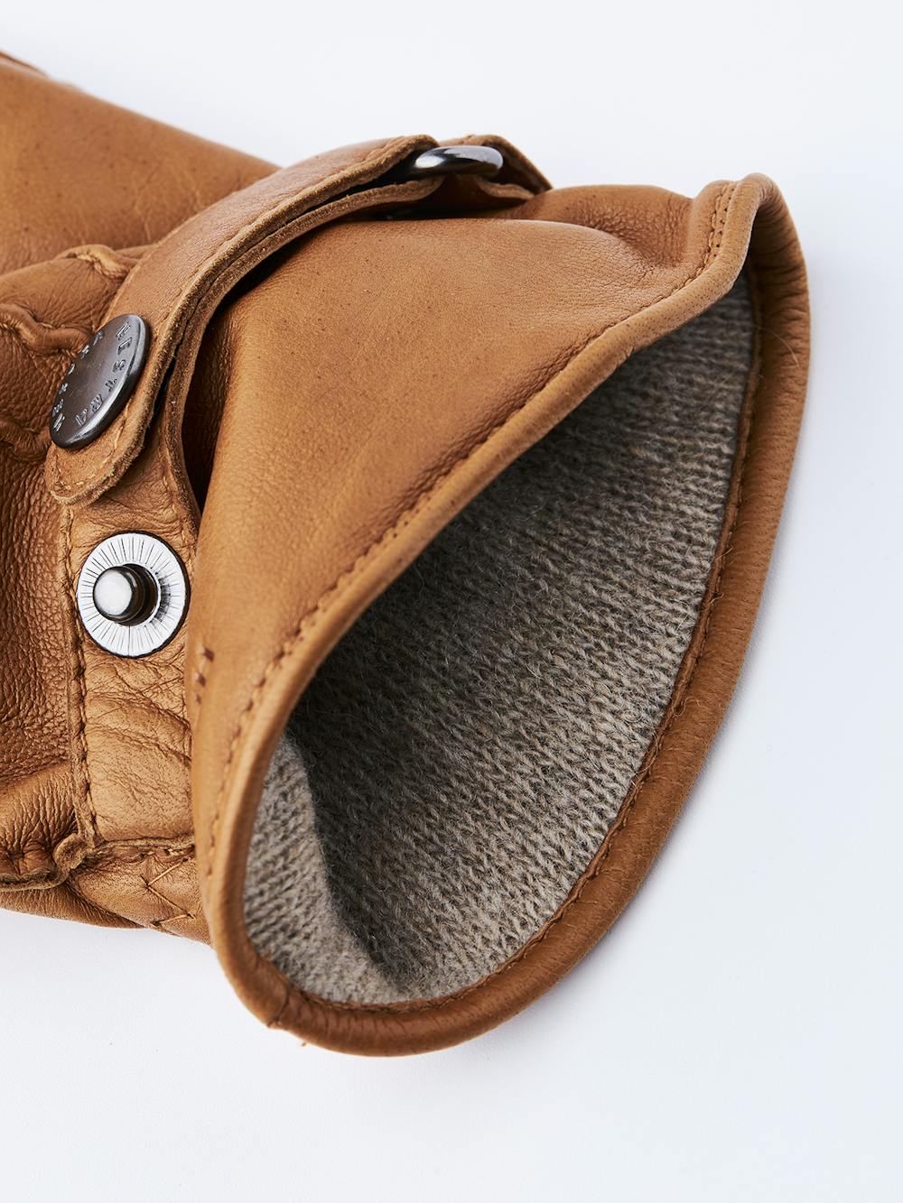 Light brownish-yellow hand-sewn hairsheep leather glove with leather strap and button
(4 of 4)