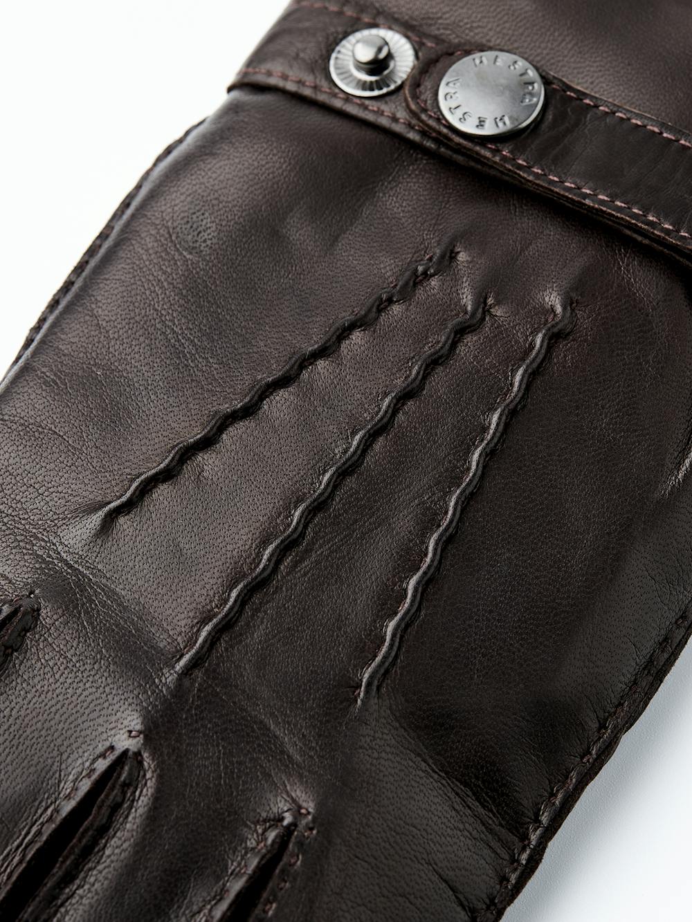 Dark brown hand-sewn hairsheep leather glove with leather strap and button
(2 of 4)