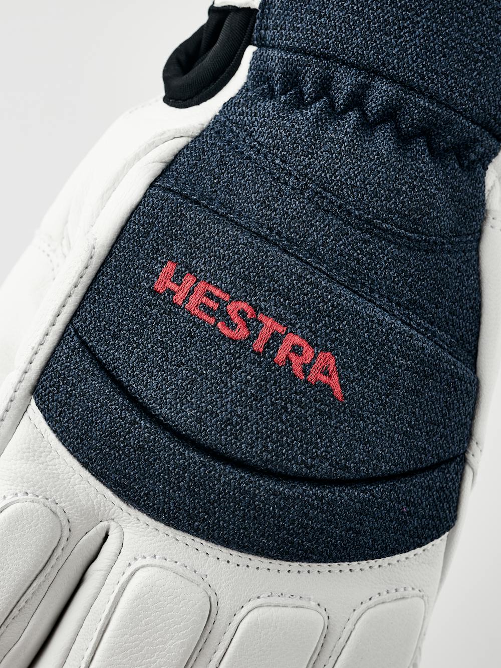 Weißer Dreifinger-Skihandschuh aus Ziegenleder und dunkelblauem Stoff auf der Oberseite mit stoßdämpfenden Polstern
(3 oder 6)