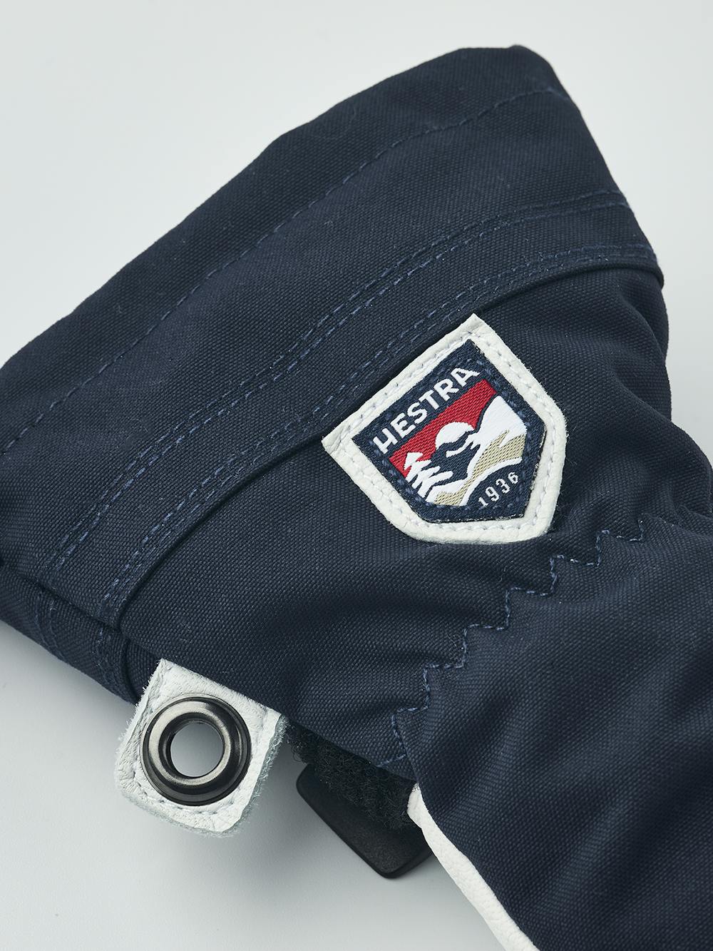 Mörkblå trefingershandske med vitt getskinn i innerhanden
 (4 oder 7)