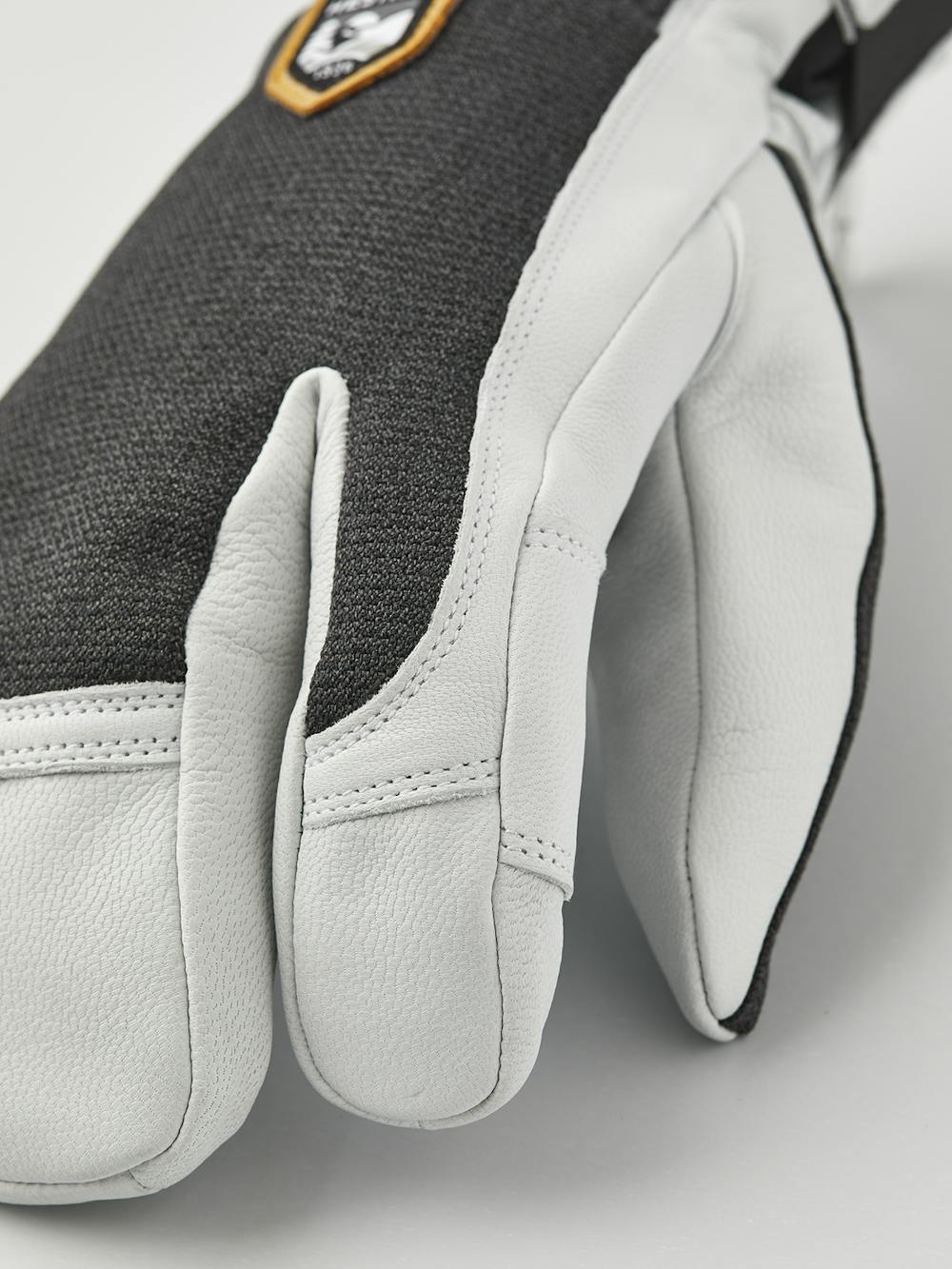 Dark gray three finger glove with white goat leather palm
 (4 of 6)