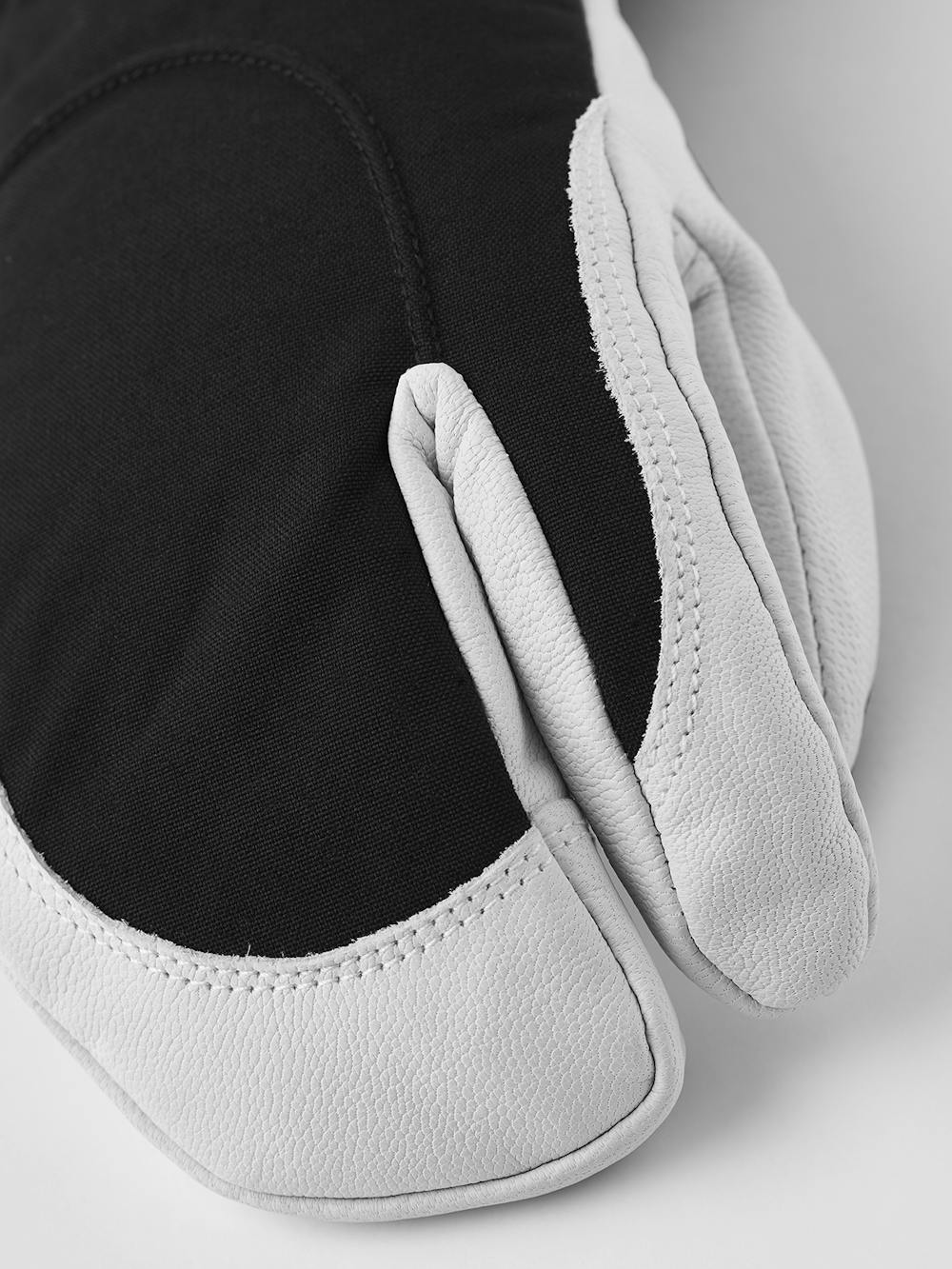 Black three finger glove with white goat leather palm
 (2 of 5)