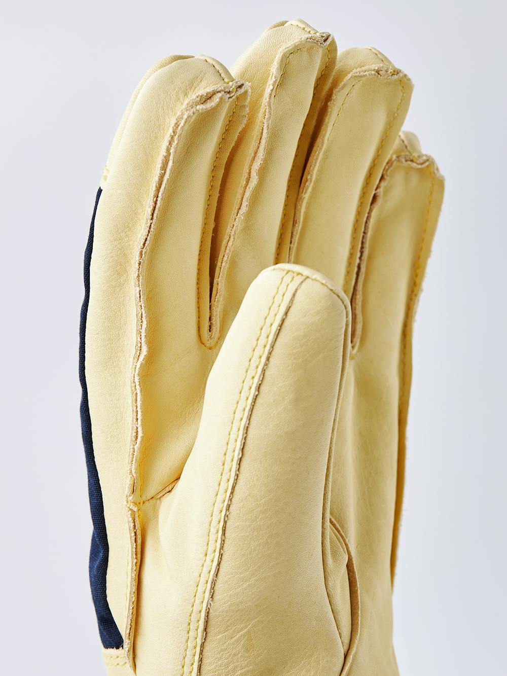 Gelber Skihandschuh aus Rindsleder mit Oberhand aus blauem Stoff
 (2 oder 9)