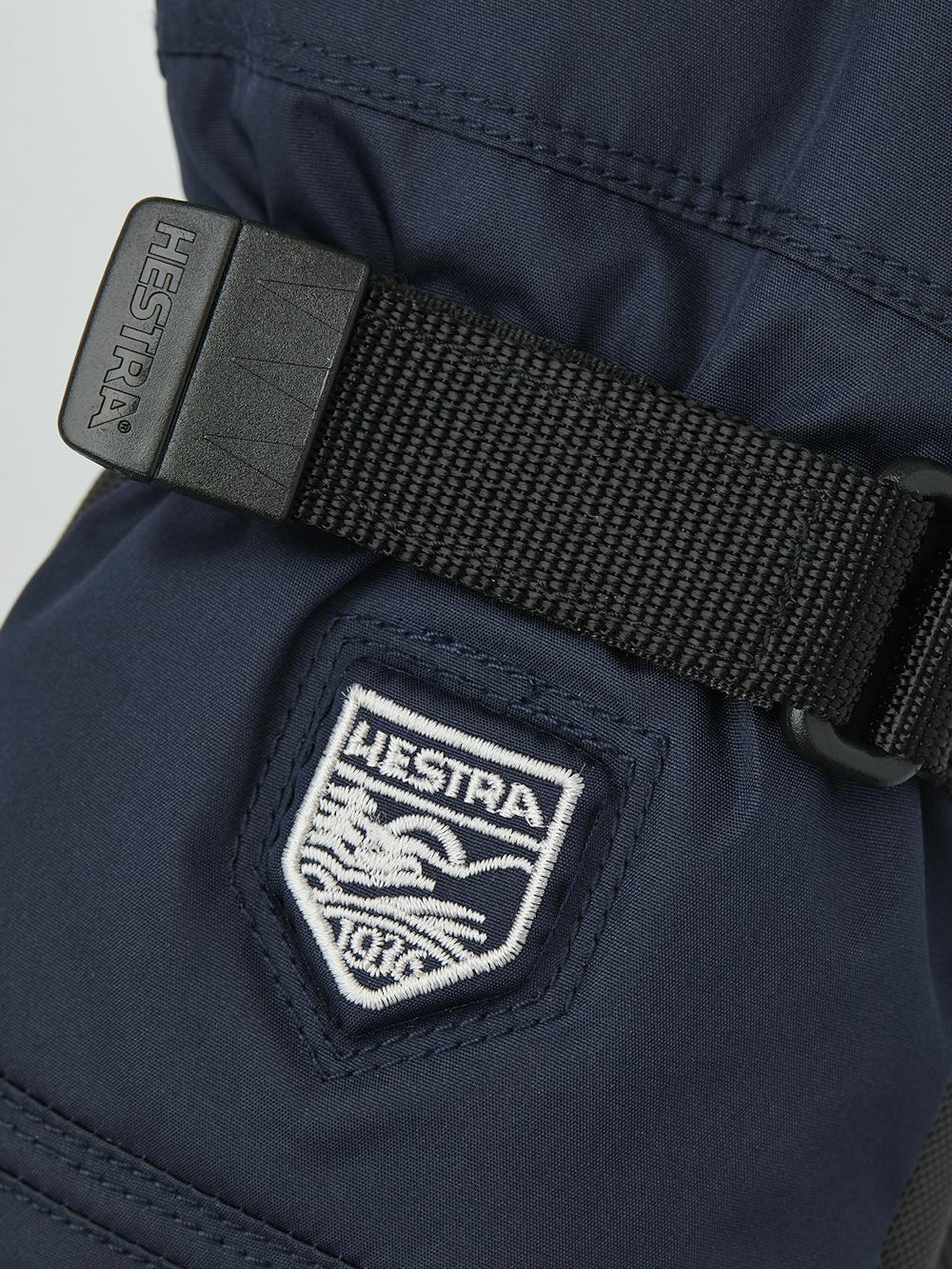 Dunkelblauer Kinderhandschuh aus Stoff mit schwarzer Innenhand aus Synthetikmaterial und verstellbarem Handgelenkverschluss (3 oder 5)