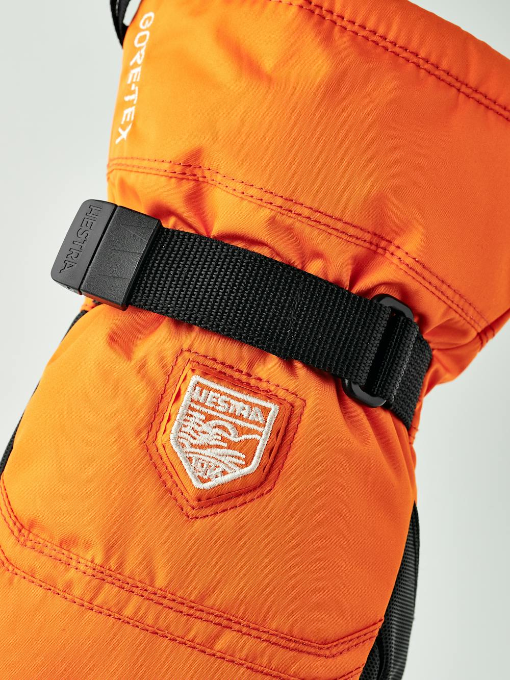 Orange tumhandske i tyg med svart innerhand i syntetmaterial och handledsjustering
(3 av 6)