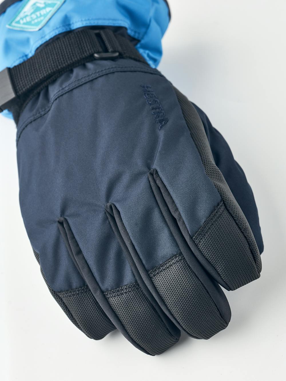 Blue children’s glove with black synthetic palm and wrist adjustment (2 of 5)