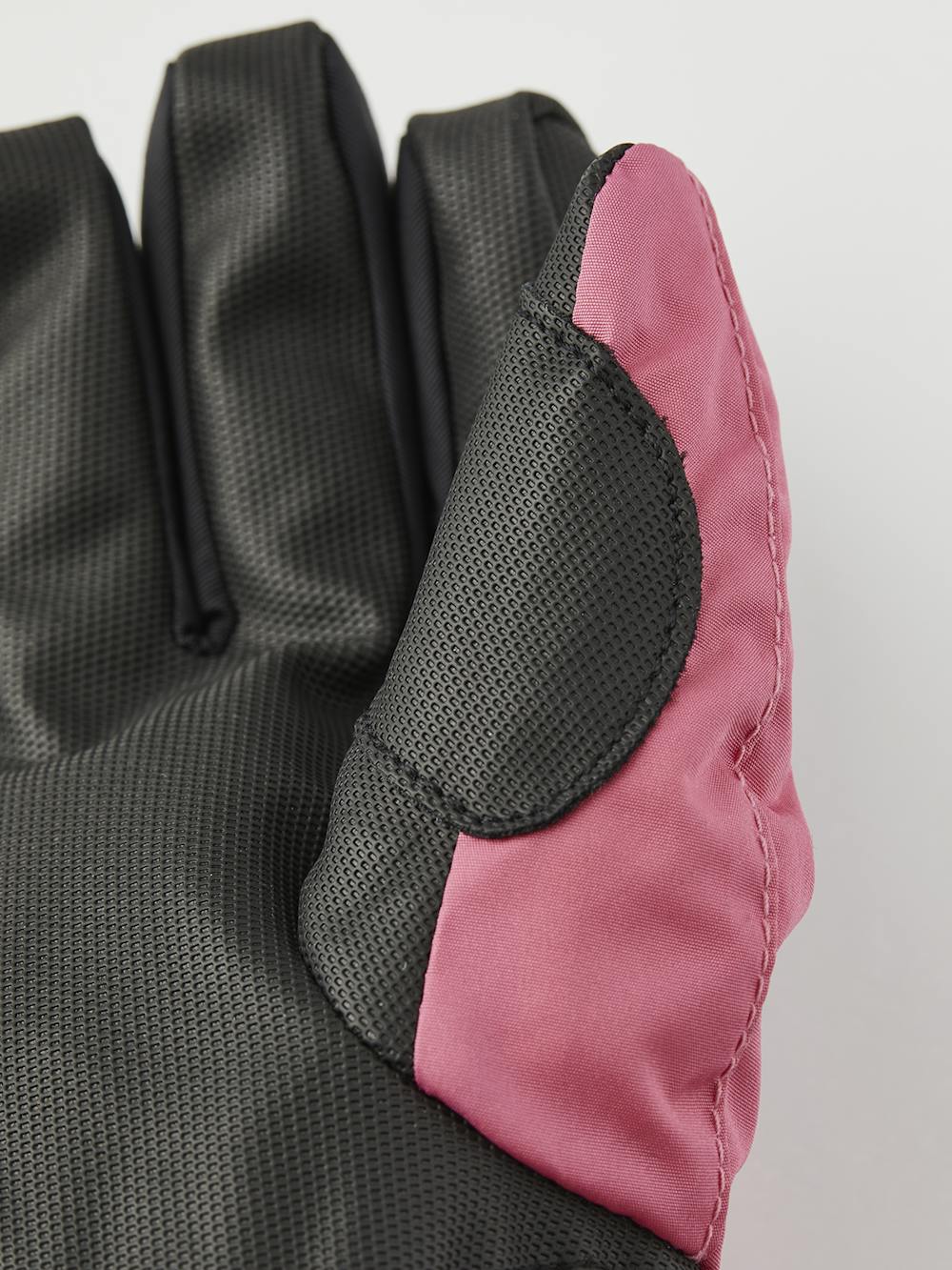 Pink children’s glove with black synthetic palm and wrist adjustment (4 of 6)