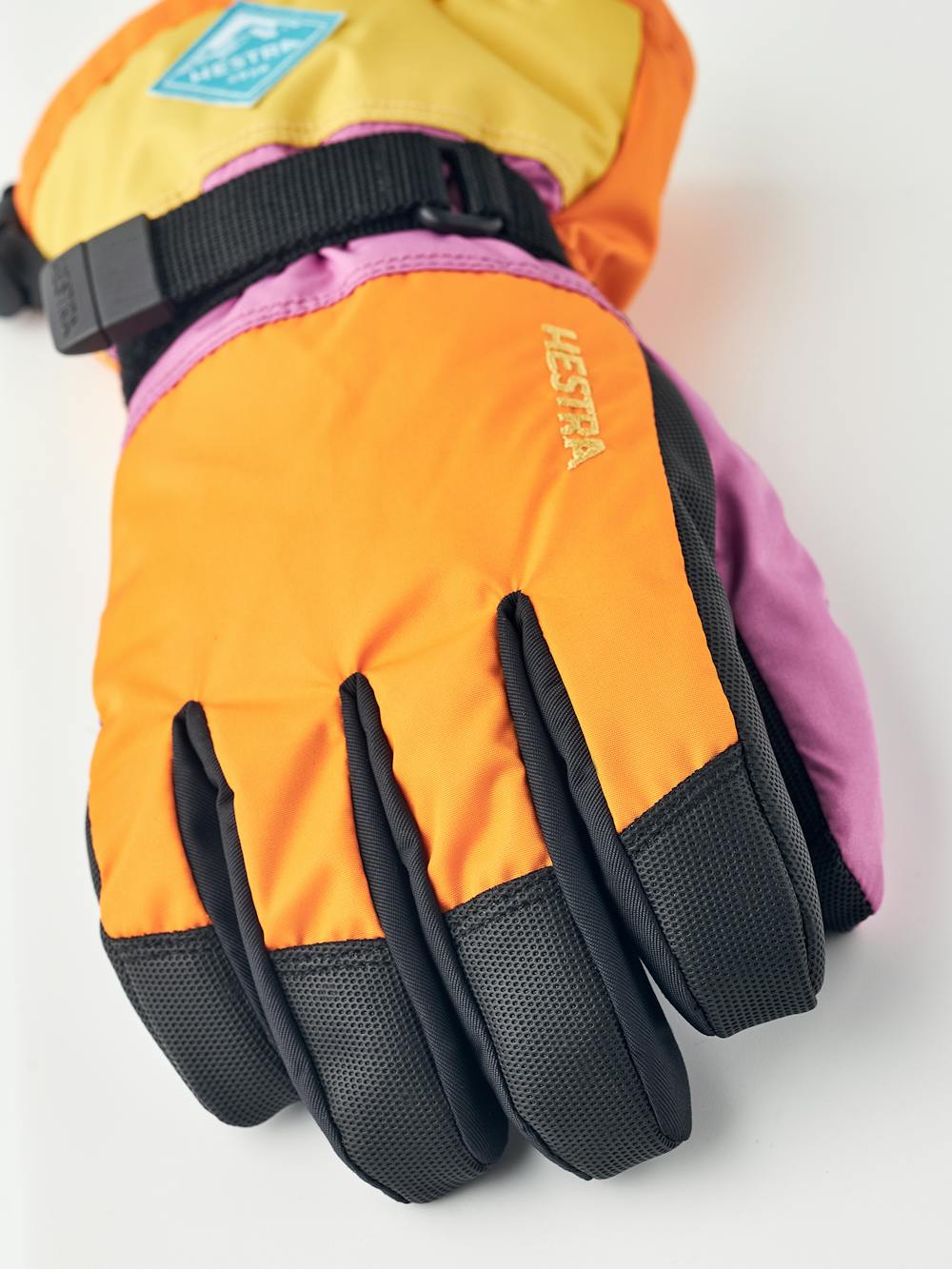 Orange und rosa Kinderhandschuh mit schwarzem Synthetikmaterial an der Innenhand und verstellbarem Handgelenkverschluss (2 oder 6)
