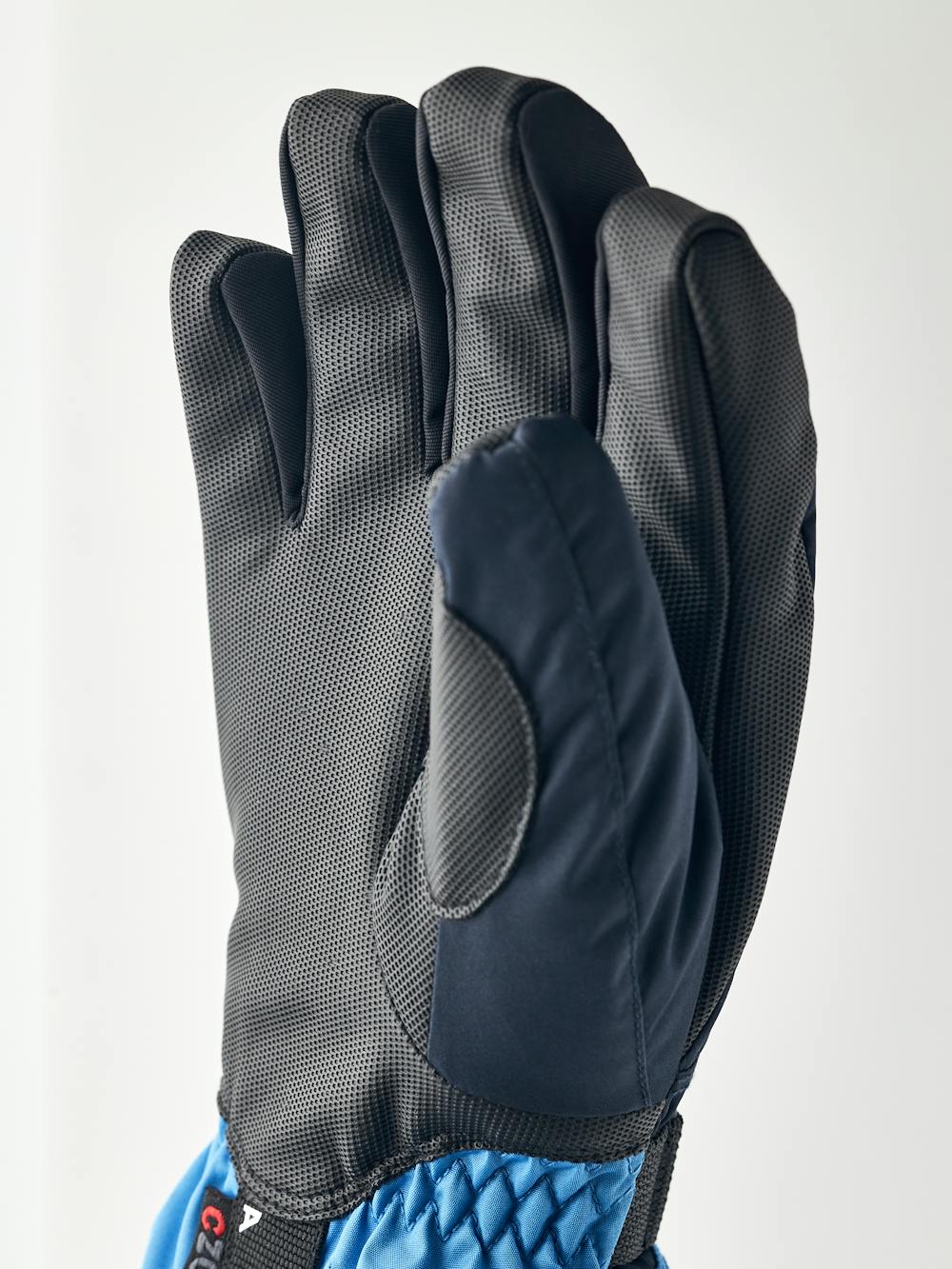 Blue children’s glove with black synthetic palm and wrist adjustment (4 of 5)