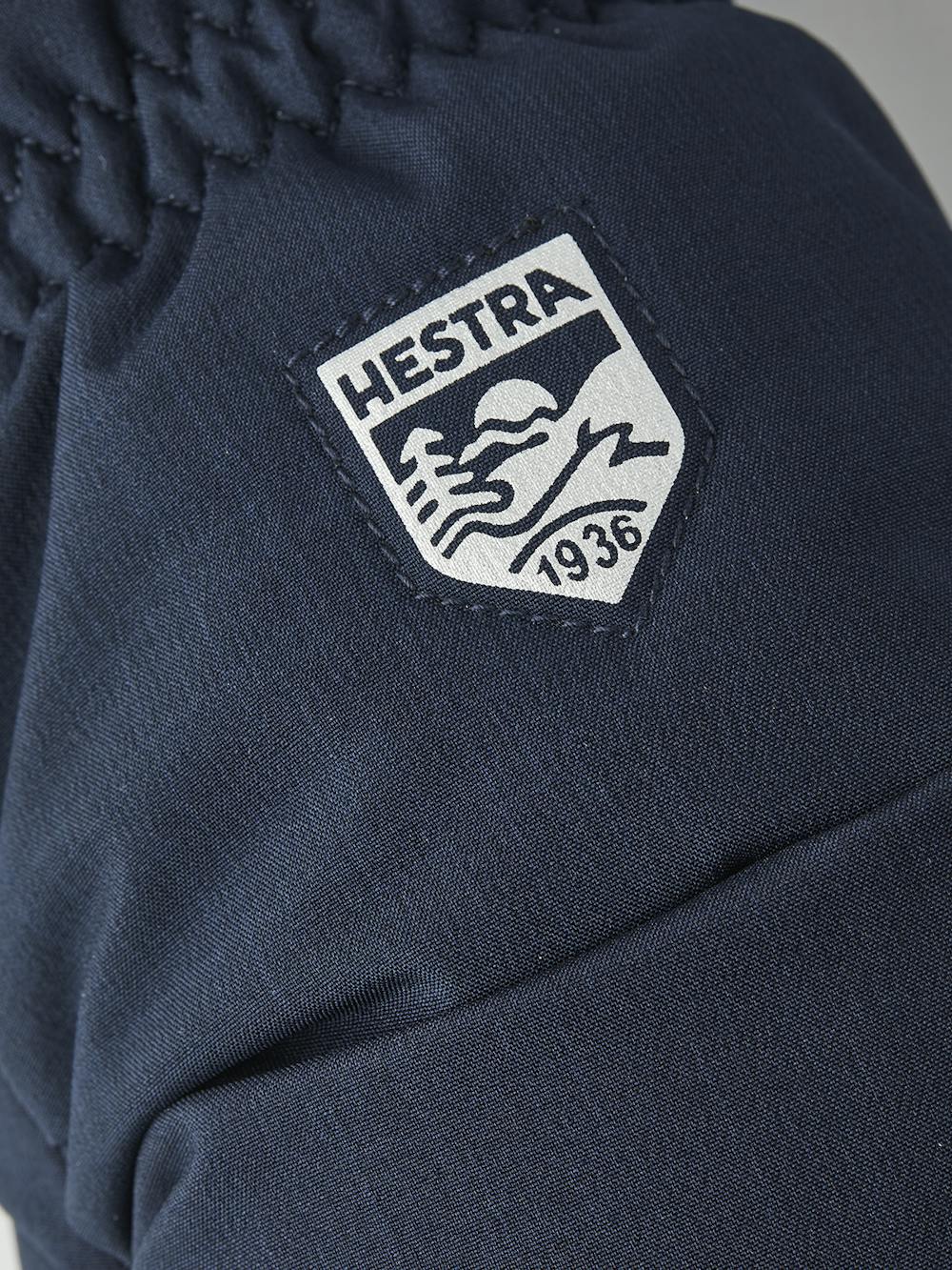 Mörkblå tumhandske med svart getskinn i innerhanden
 (3 av 4)