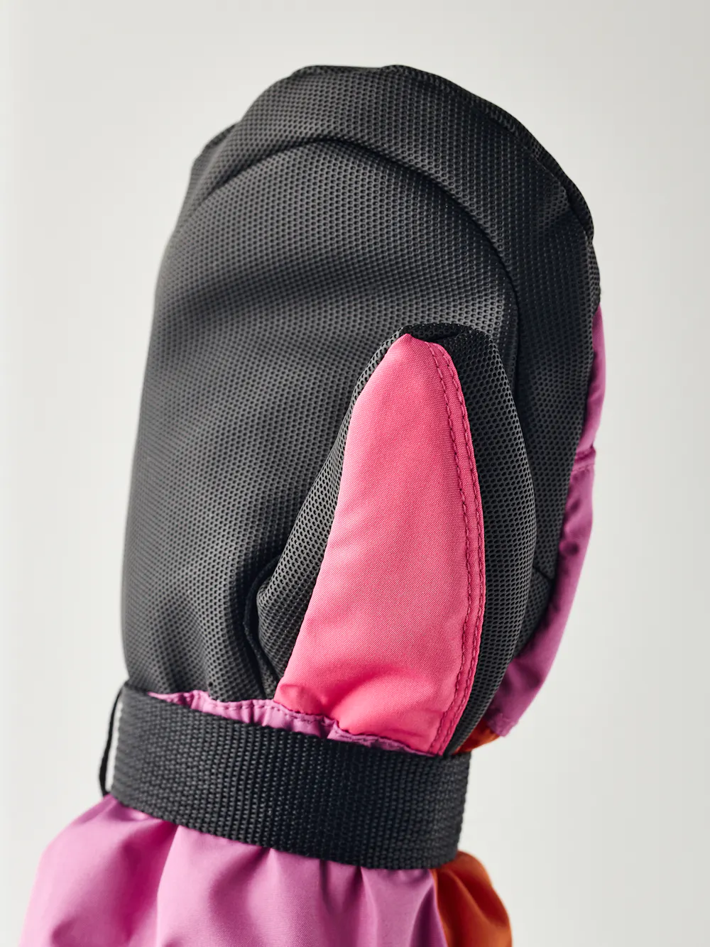 Orange and pink fabric mitten with black synthetic palm and wrist adjustment (3 of 5)