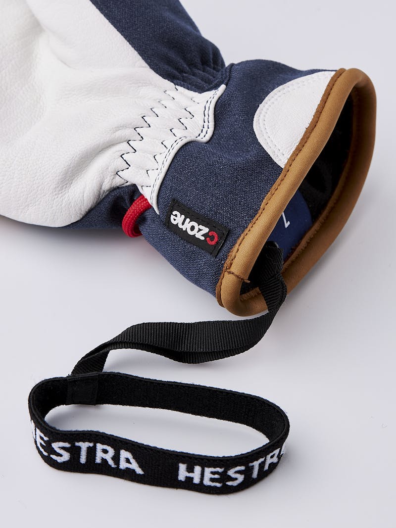 Mörkblå tumhandske med vitt getskinn i innerhanden och handledsrem
 (5 av 5)