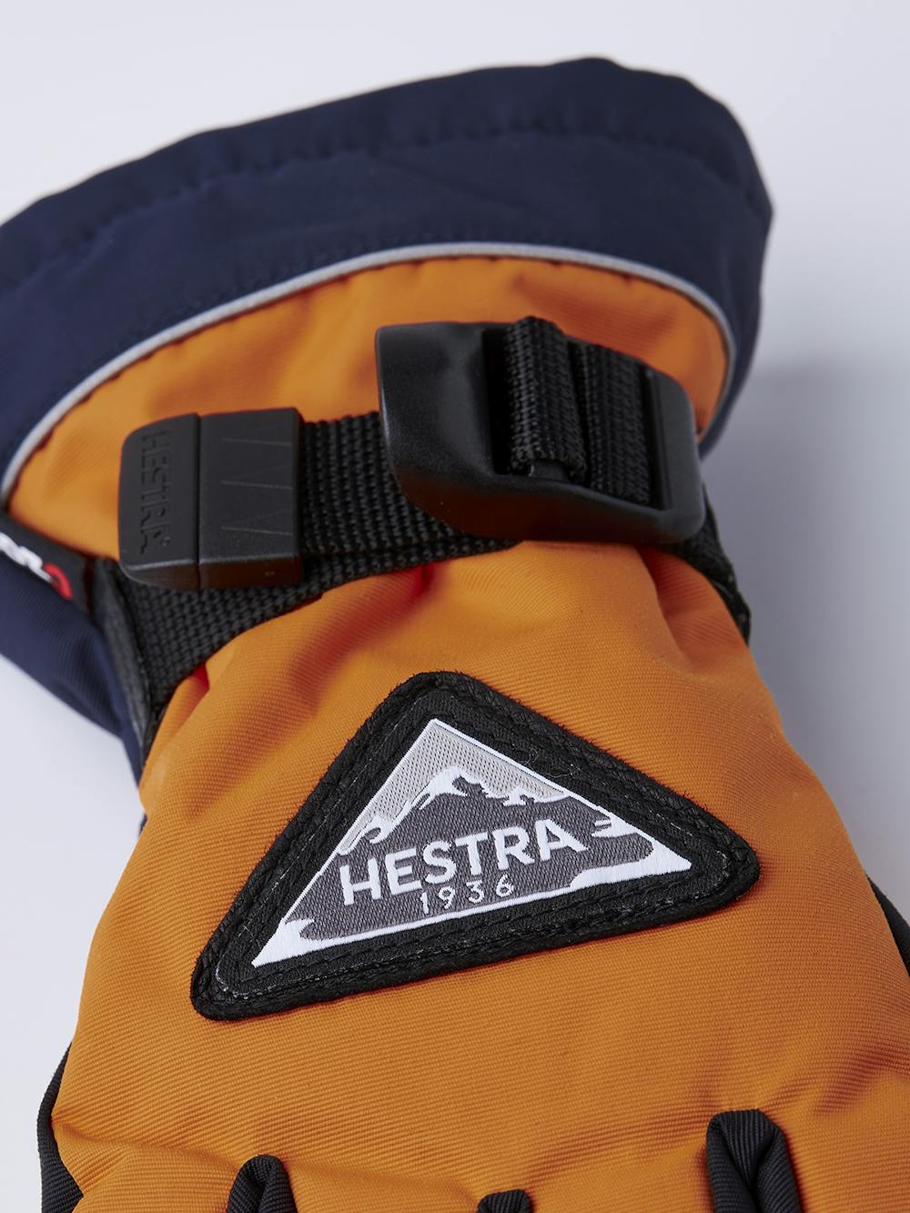 Oranger Kinderhandschuh mit schwarzem Ziegenleder an der Innenhand und verstellbarem Handgelenkverschluss (4 oder 8)