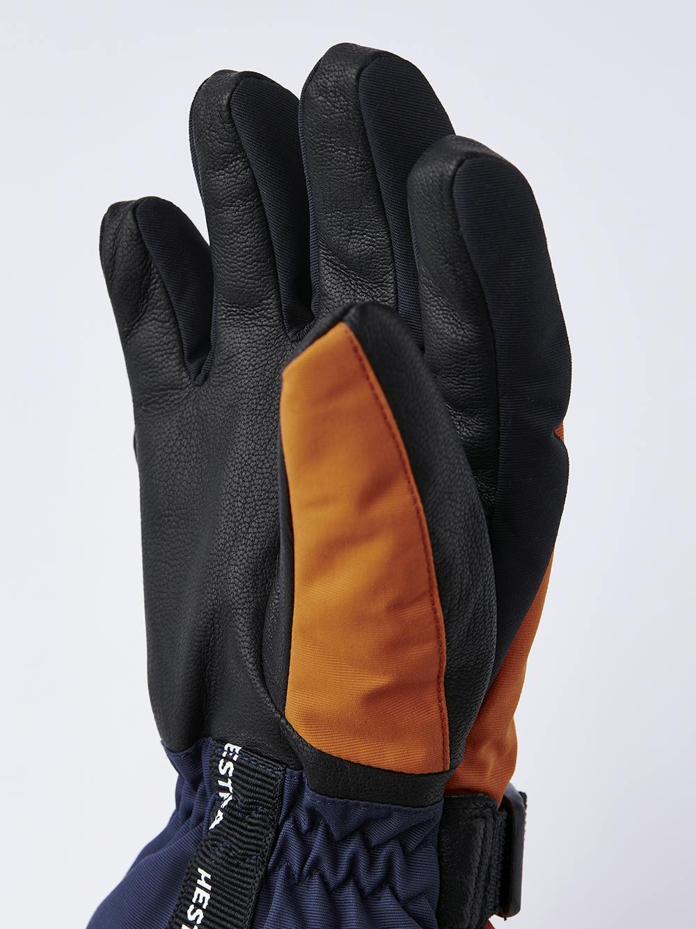 Oranger Kinderhandschuh mit schwarzem Ziegenleder an der Innenhand und verstellbarem Handgelenkverschluss (3 oder 8)