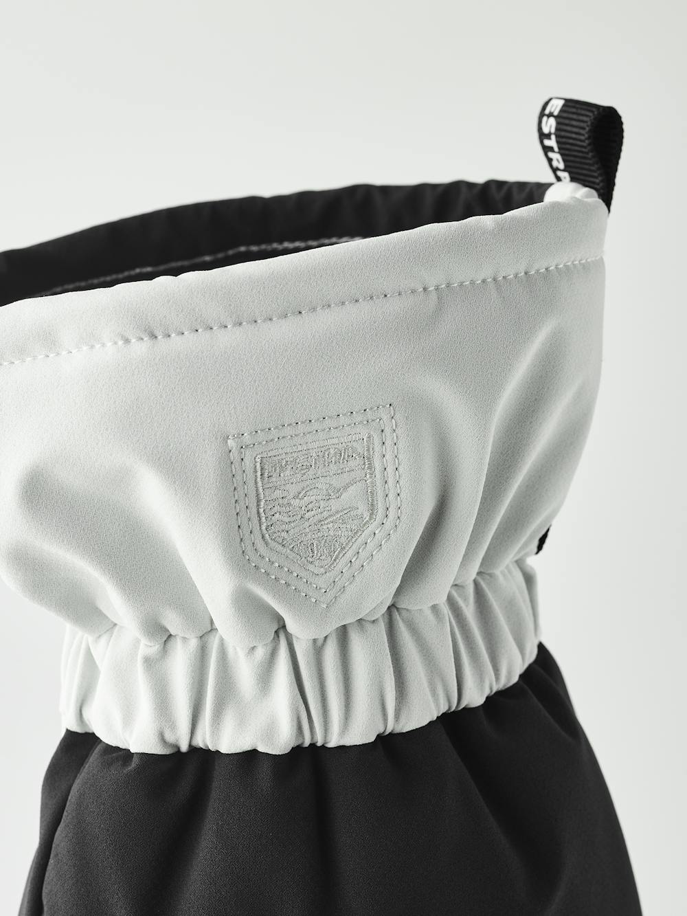 Schwarz-weißer Skihandschuh aus Stoff mit weißem Ziegenleder an der Innenhand (5 oder 7)