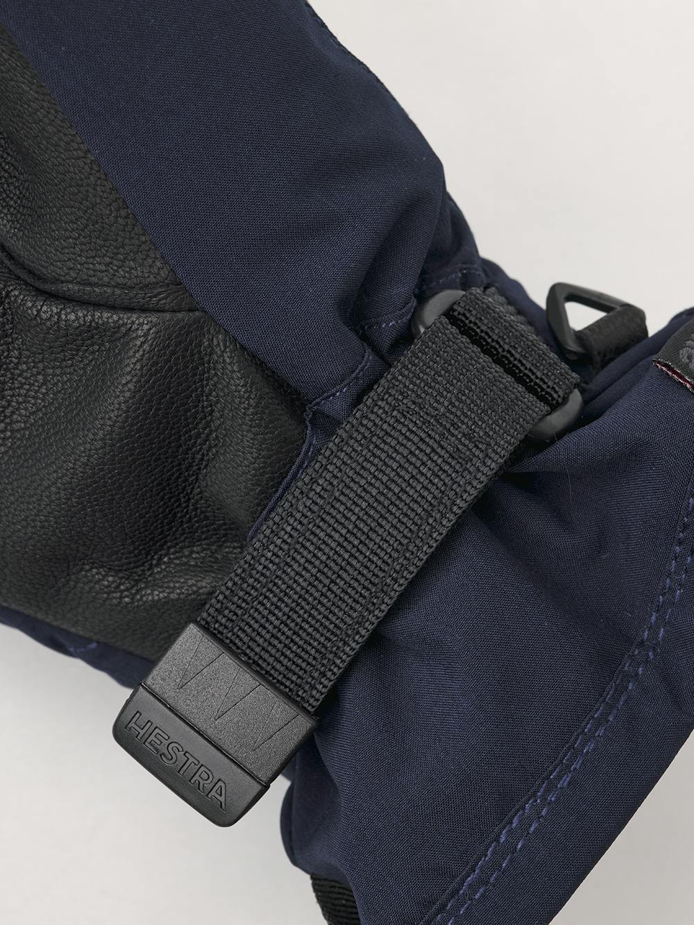 Mörkblå tumhandske i tyg med svart lammnappa i innerhanden och handledsjustering
(3 av 6)