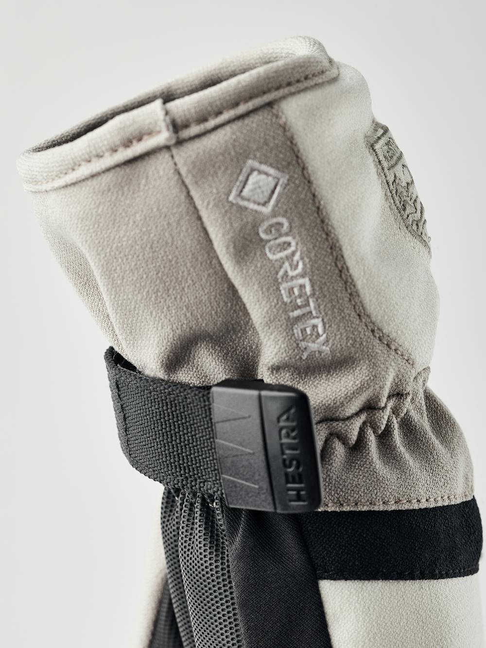 Beige and white fabric children’s glove with black synthetic palm and wrist adjustment (5 of 5)