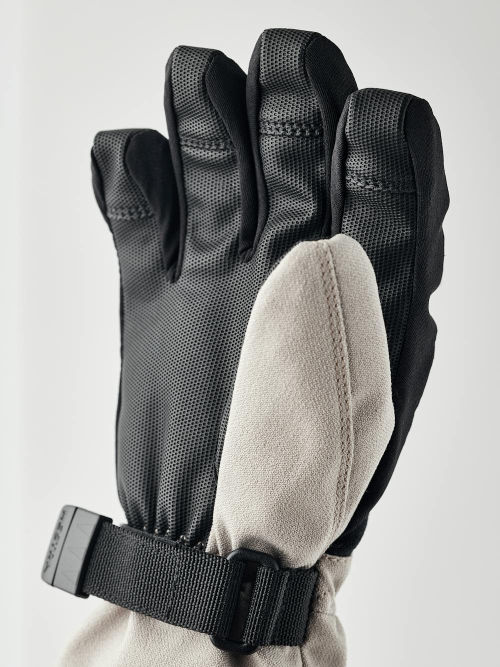 Beige and white fabric children’s glove with black synthetic palm and wrist adjustment (4 of 5)
