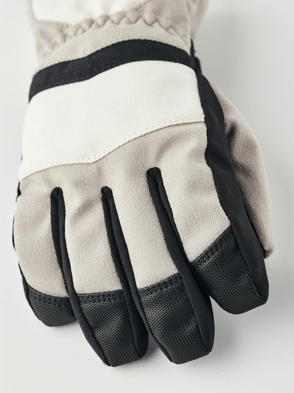 Beige and white fabric children’s glove with black synthetic palm and wrist adjustment (2 of 5)