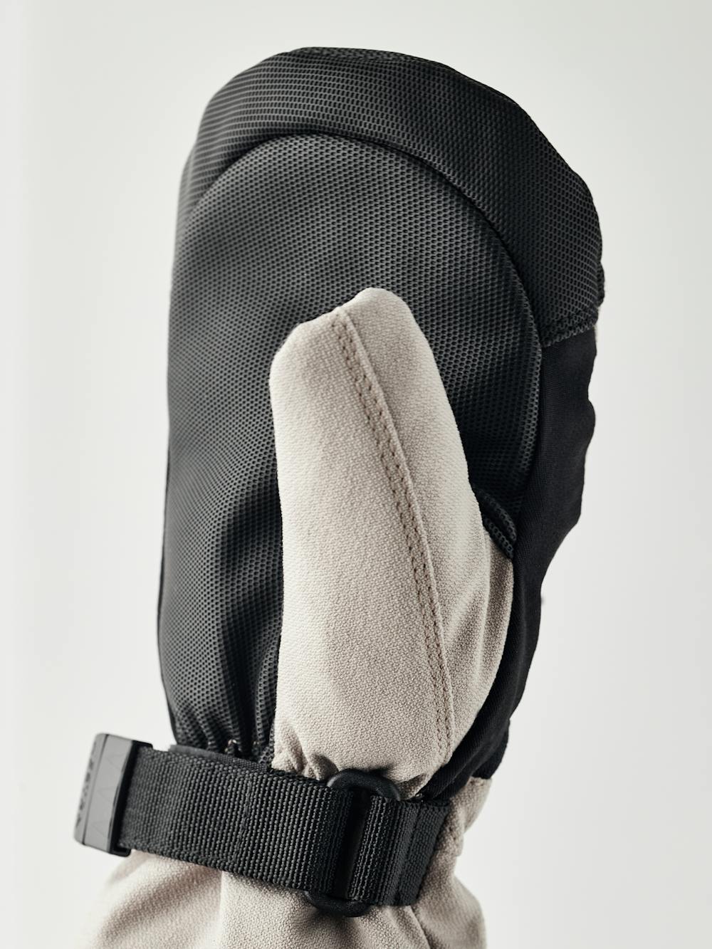 Beige and white fabric mitten with black synthetic palm and wrist adjustment (4 of 5)