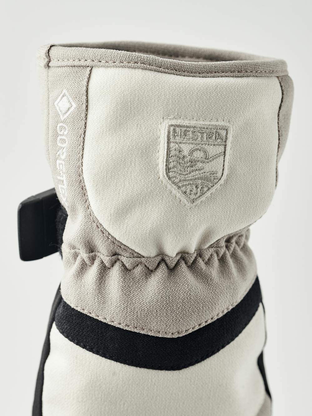 Beige and white fabric mitten with black synthetic palm and wrist adjustment (3 of 5)